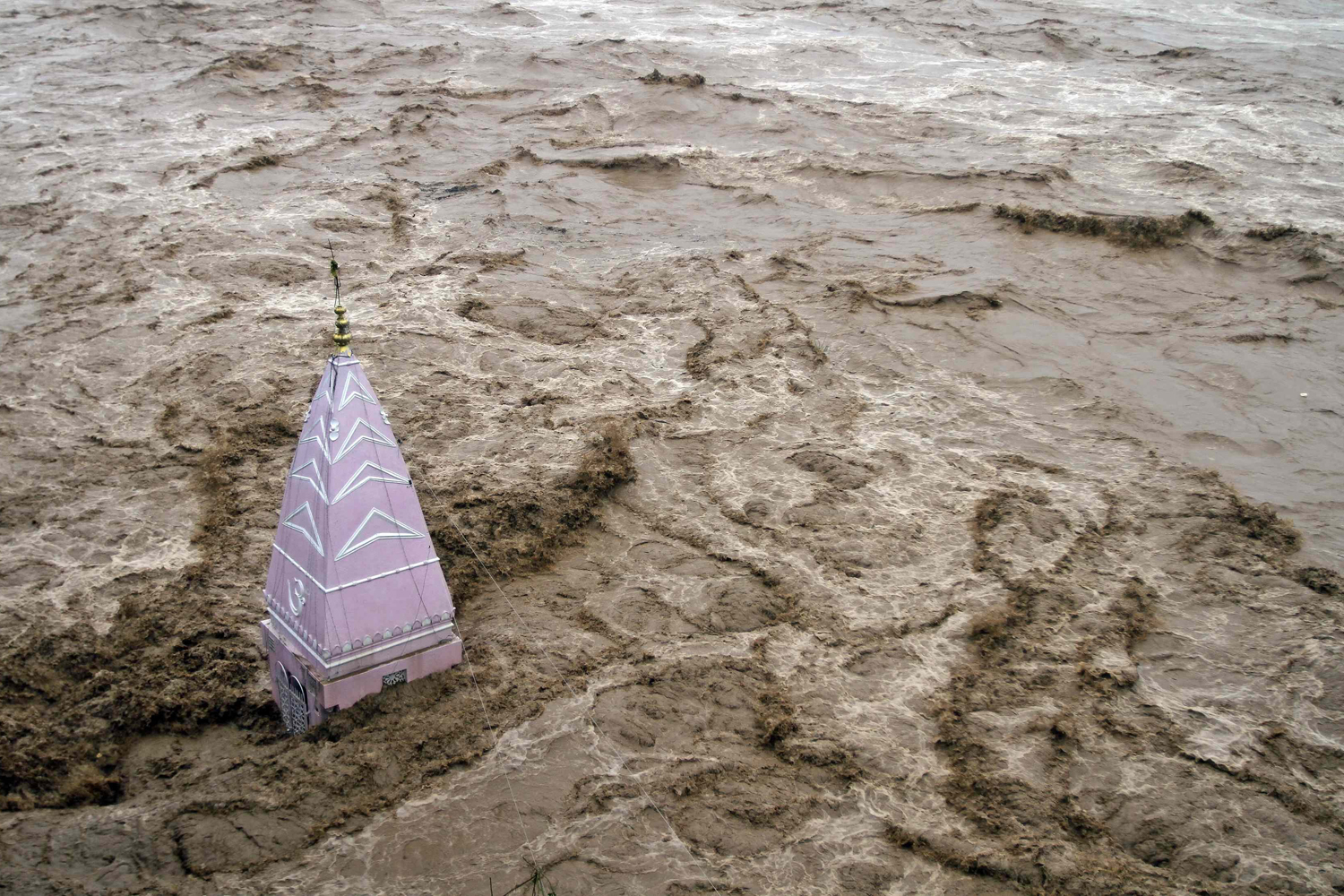 Sept. 6, 2014. A temple stands amid the waters of the overflowing river Tawi during heavy rains in Jammu. Authorities declared a disaster alert in the northern region after heavy rain hit villages across the Kashmir valley, causing the worst flooding in two decades.