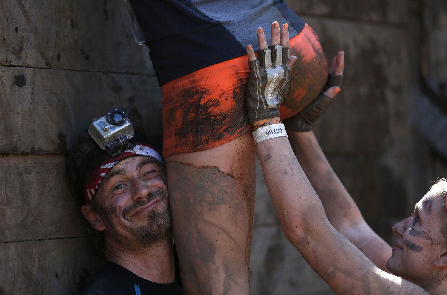 Participants climb over a wall at the "Tough Mudder" endurance event series in Arnsberg, Germany on Sept. 6, 2014.