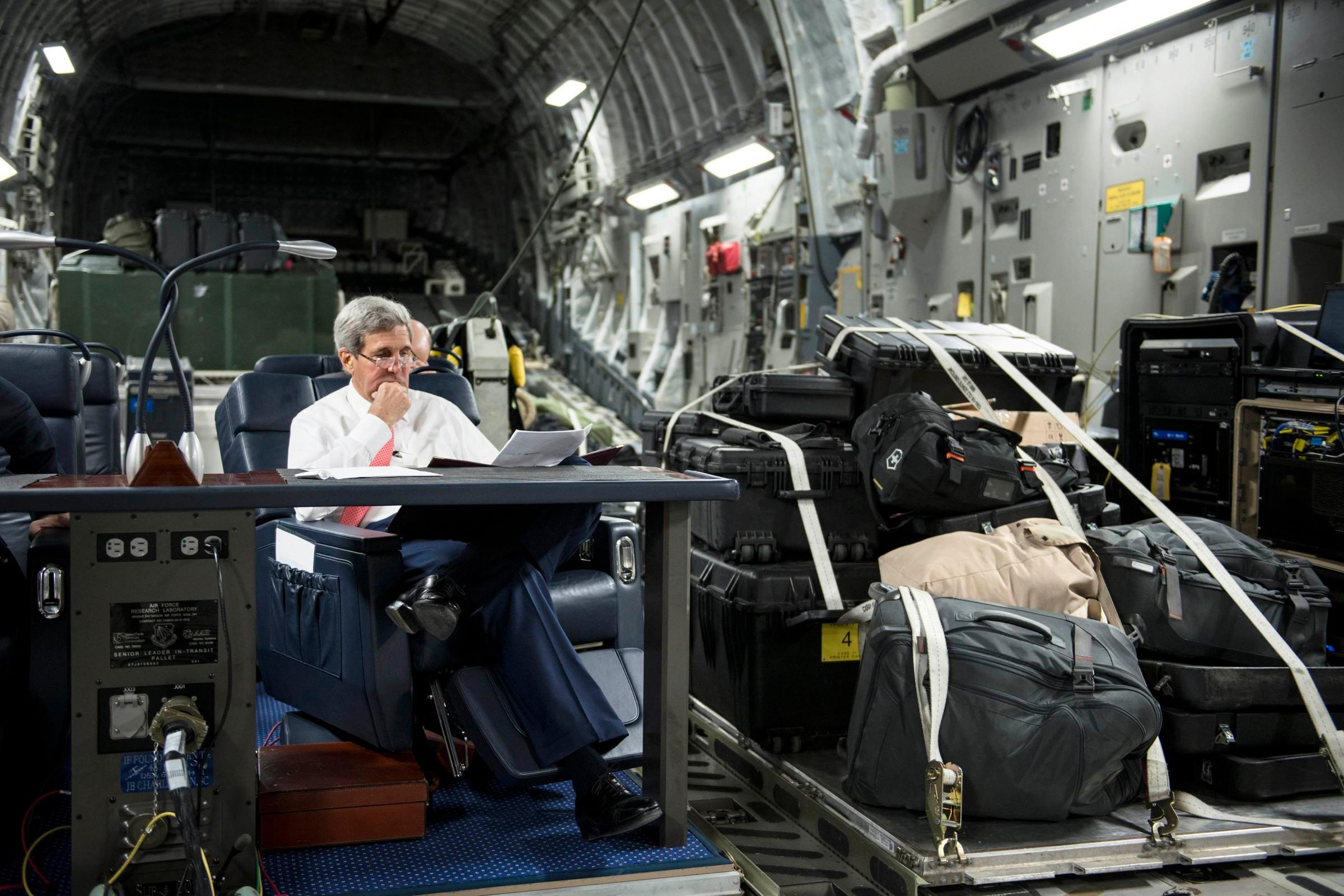 U.S. Secretary of State John Kerry looks over papers while flying from Jordan to Iraq on Sept. 10, 2014.