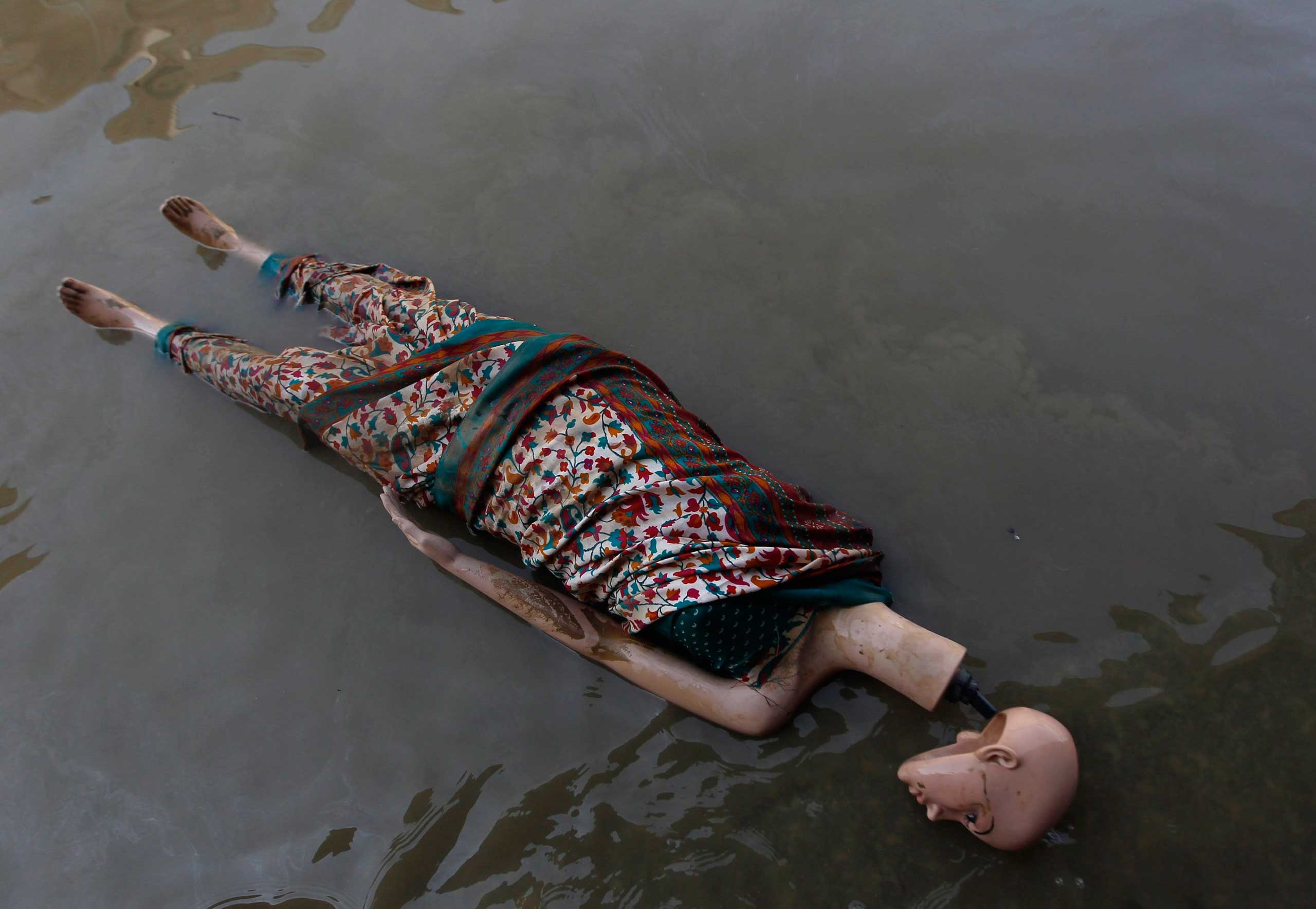 Sept. 16, 2014. A mannequin floats in the floodwaters along a street in Srinagar, India.