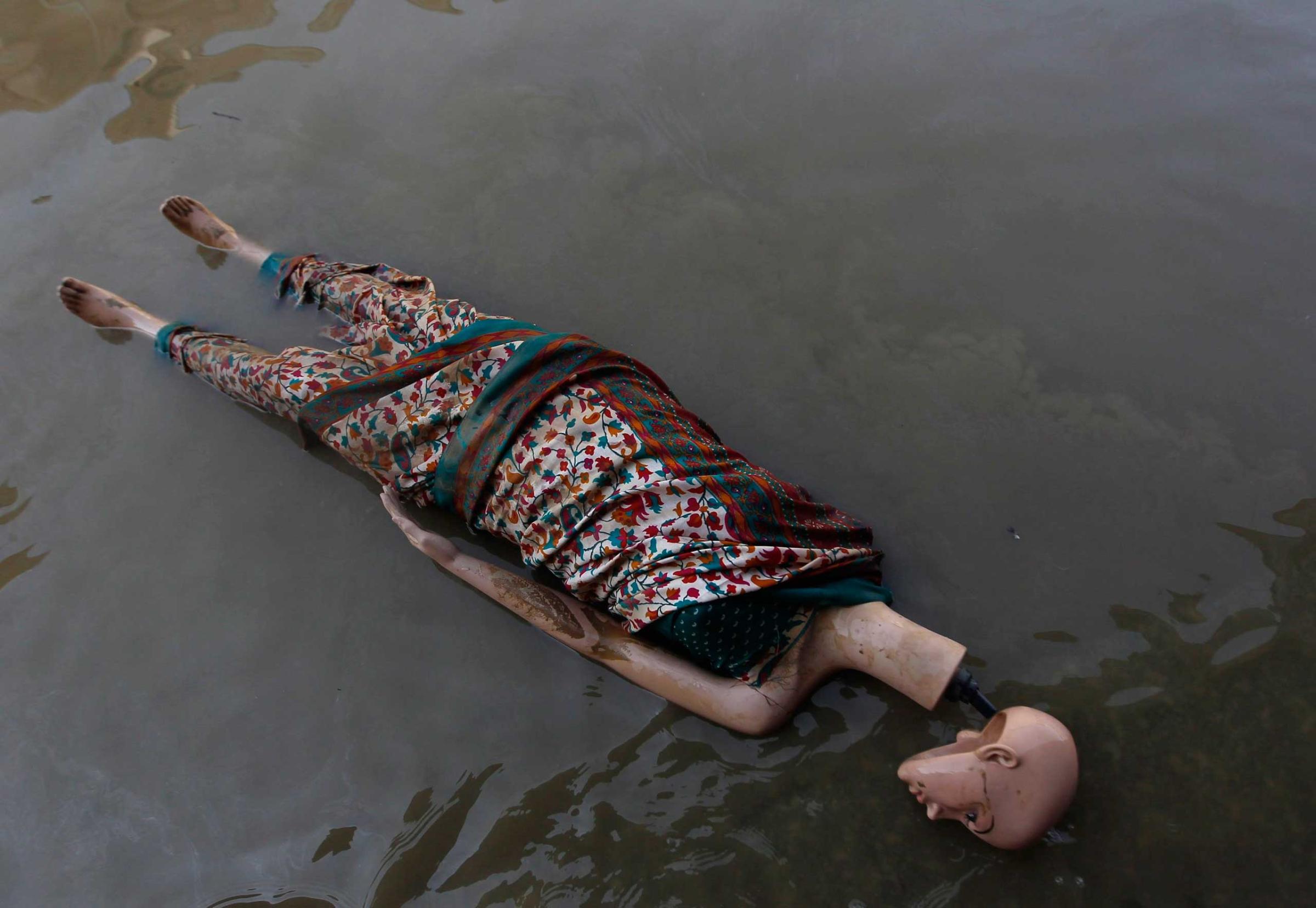 A mannequin floats in the floodwaters along a street in Srinagar