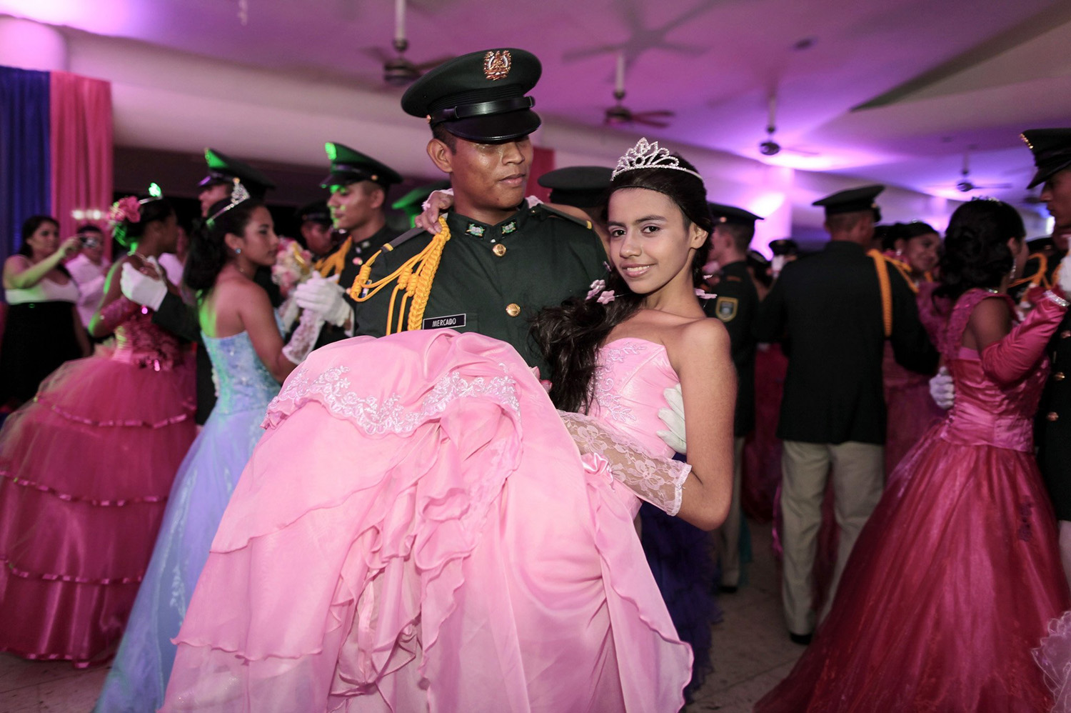 A cancer patient dances with a cadet from Nicaragua's Military Academy during her "Quinceanera" (15th birthday) party at a hotel in Managua
