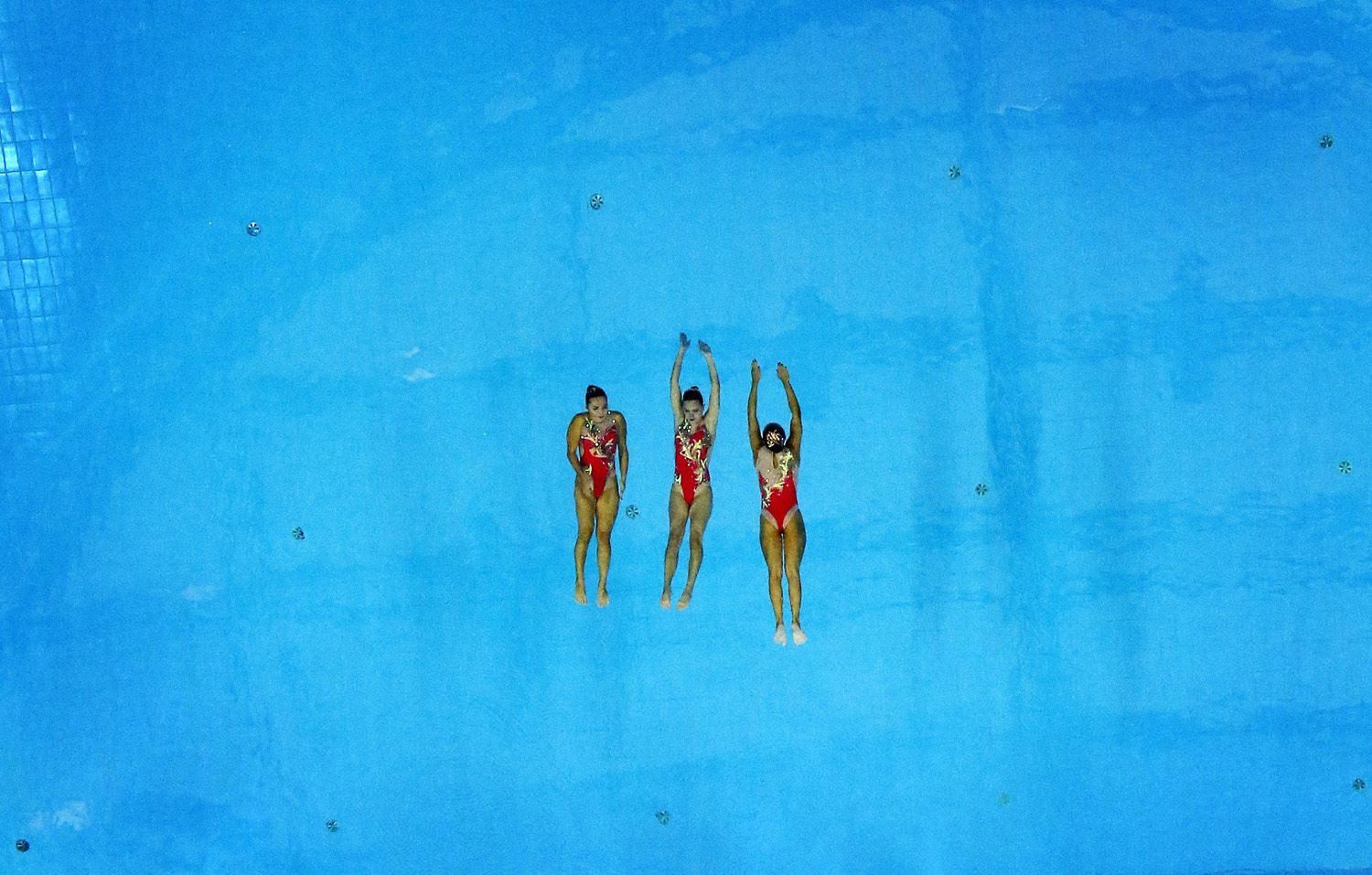 Three members of the bronze medal winning Kazakhstan team perform during their Synchronised Swimming Free Combination routine during the 17th Asian Games in Incheon