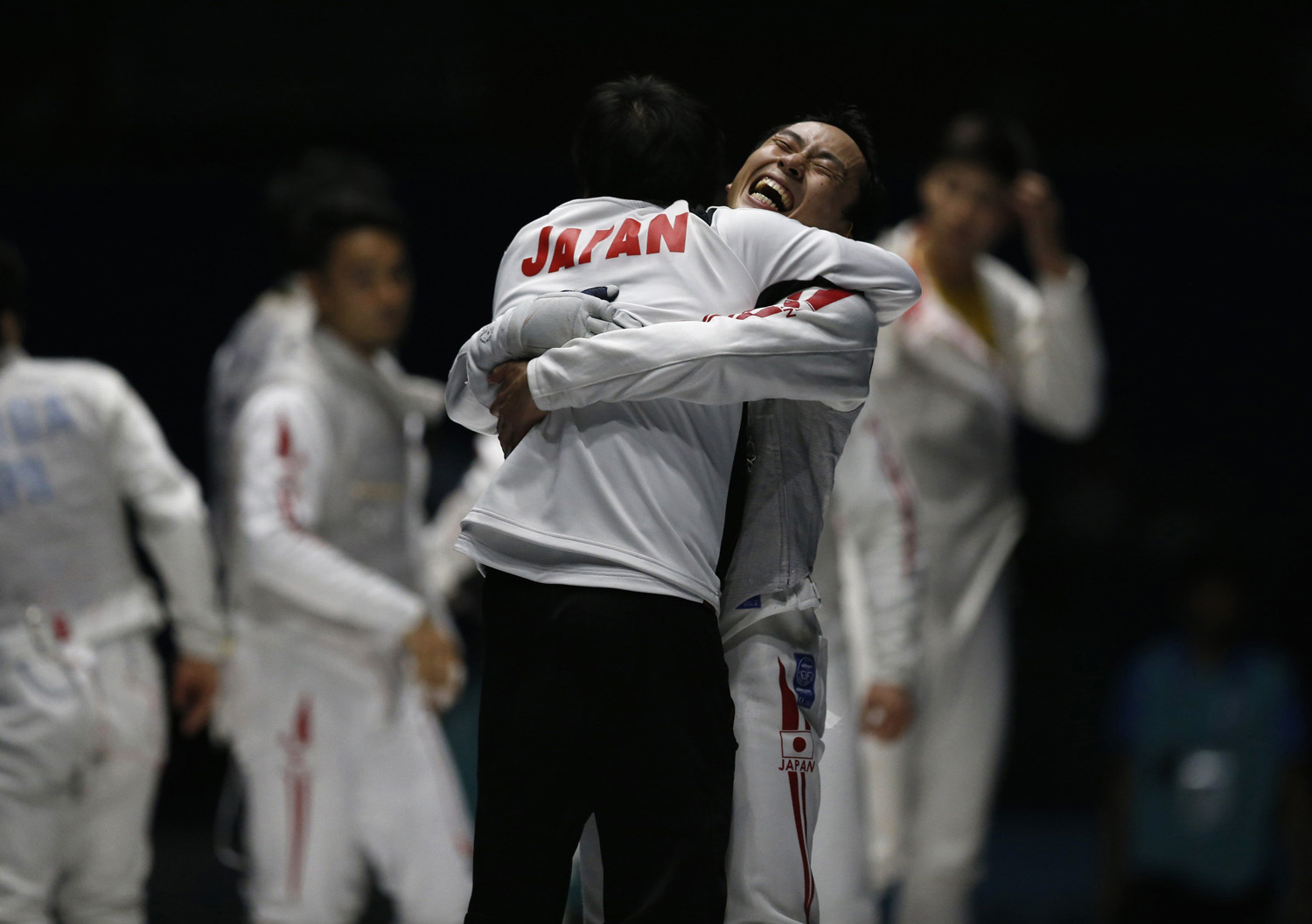 Japan's Ota celebrates with team member after winning their men's foil team fencing competition final against China at Goyang Gymnasium during the 17th Asian Games in Incheon