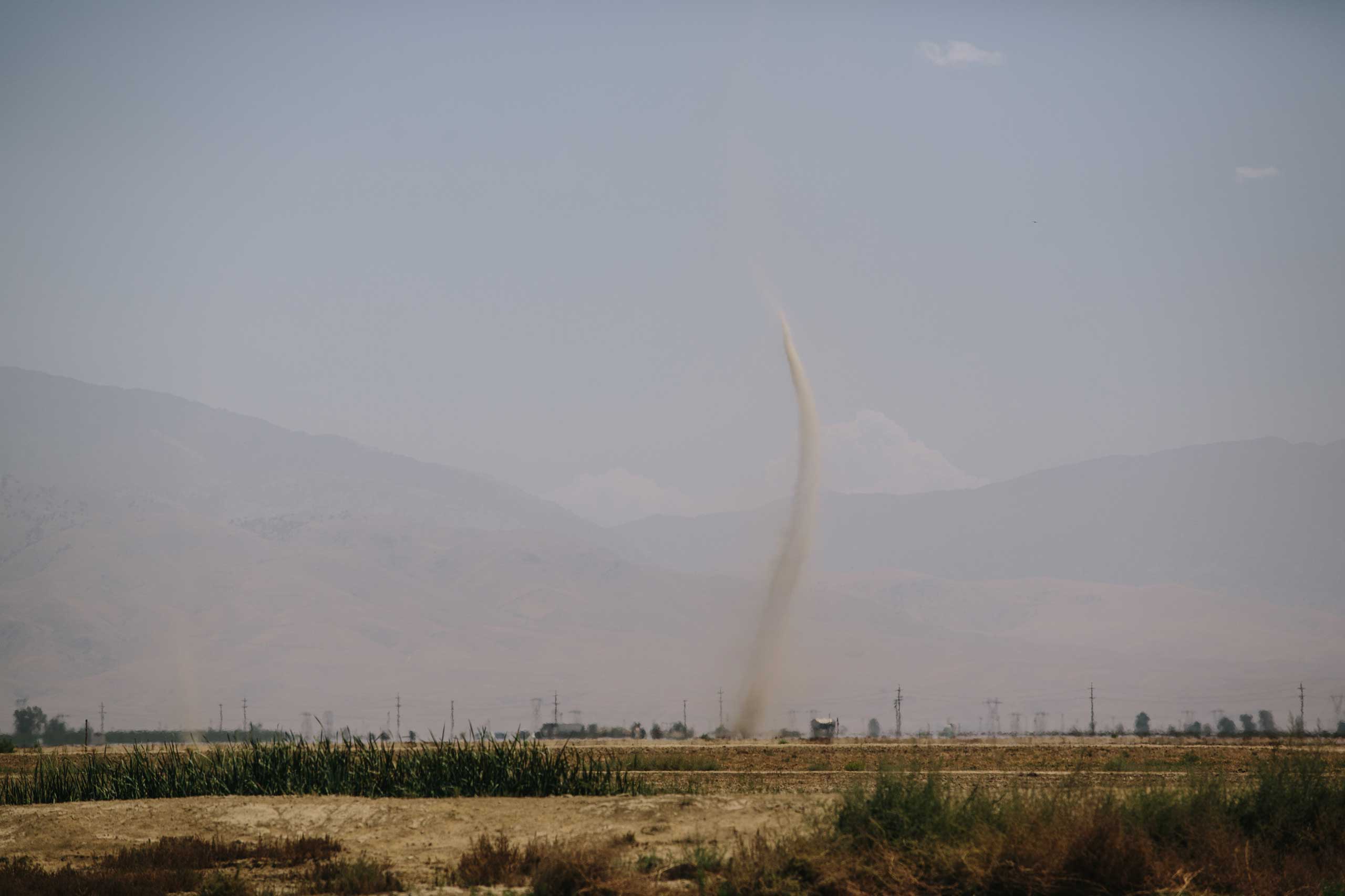 Dust devils can be seen reaching toward the sky during dry months in Bakersfield. Dust is a pervasive problem that contributes to diminished air quality. The problem is exacerbated by the current drought in California.