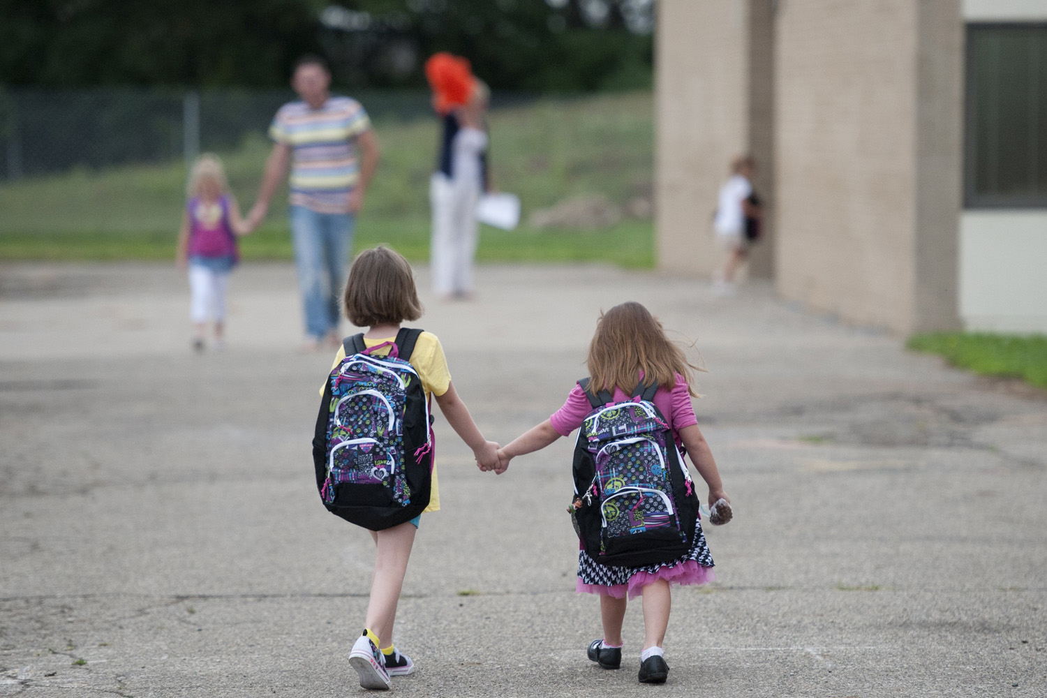 Students hold hands as they walk from the bus to classrooms at Parnall Elementary School in Jackson, Miss. on Sept. 2, 2014.