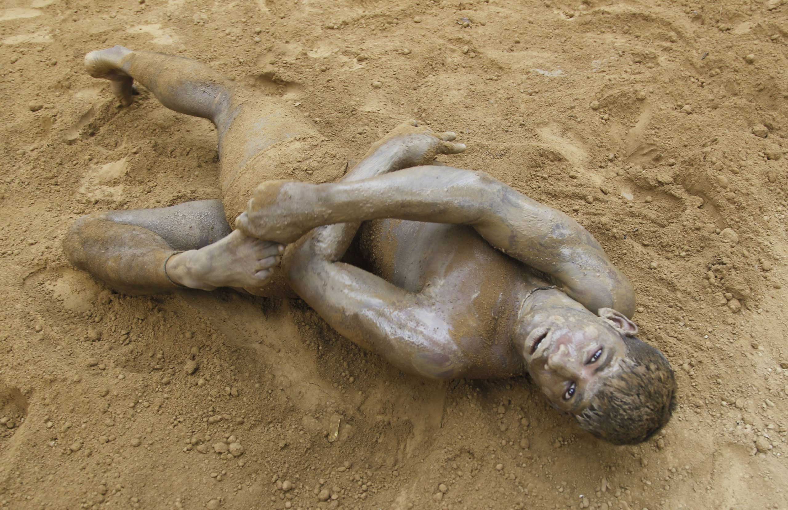 Sept. 12, 2014. Wrestlers seen practicing in the mud at a traditional wrestling rink in Uttar Pradesh, India.