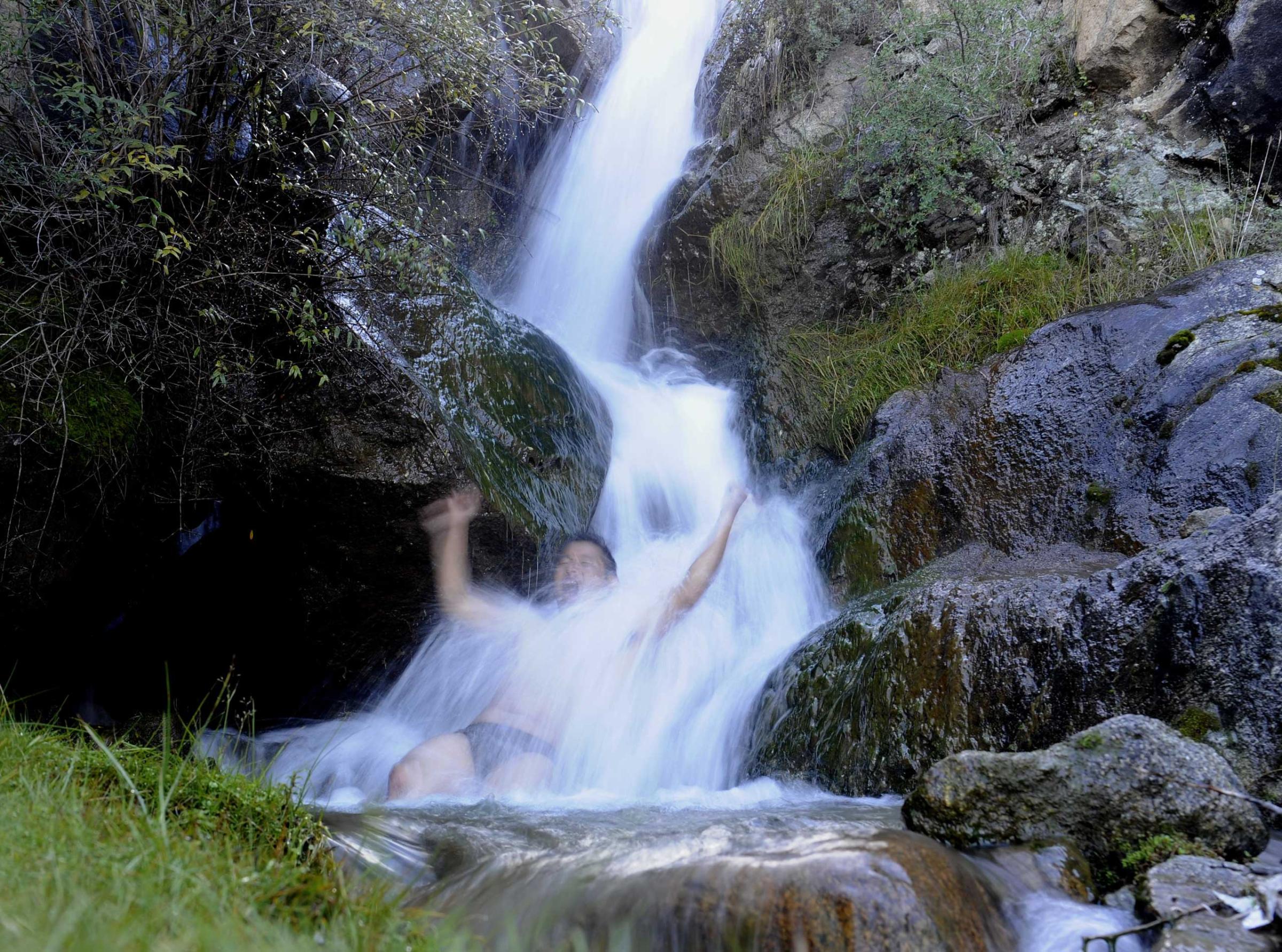 A man takes a bath in a stream on the outskirts of Lhasa,