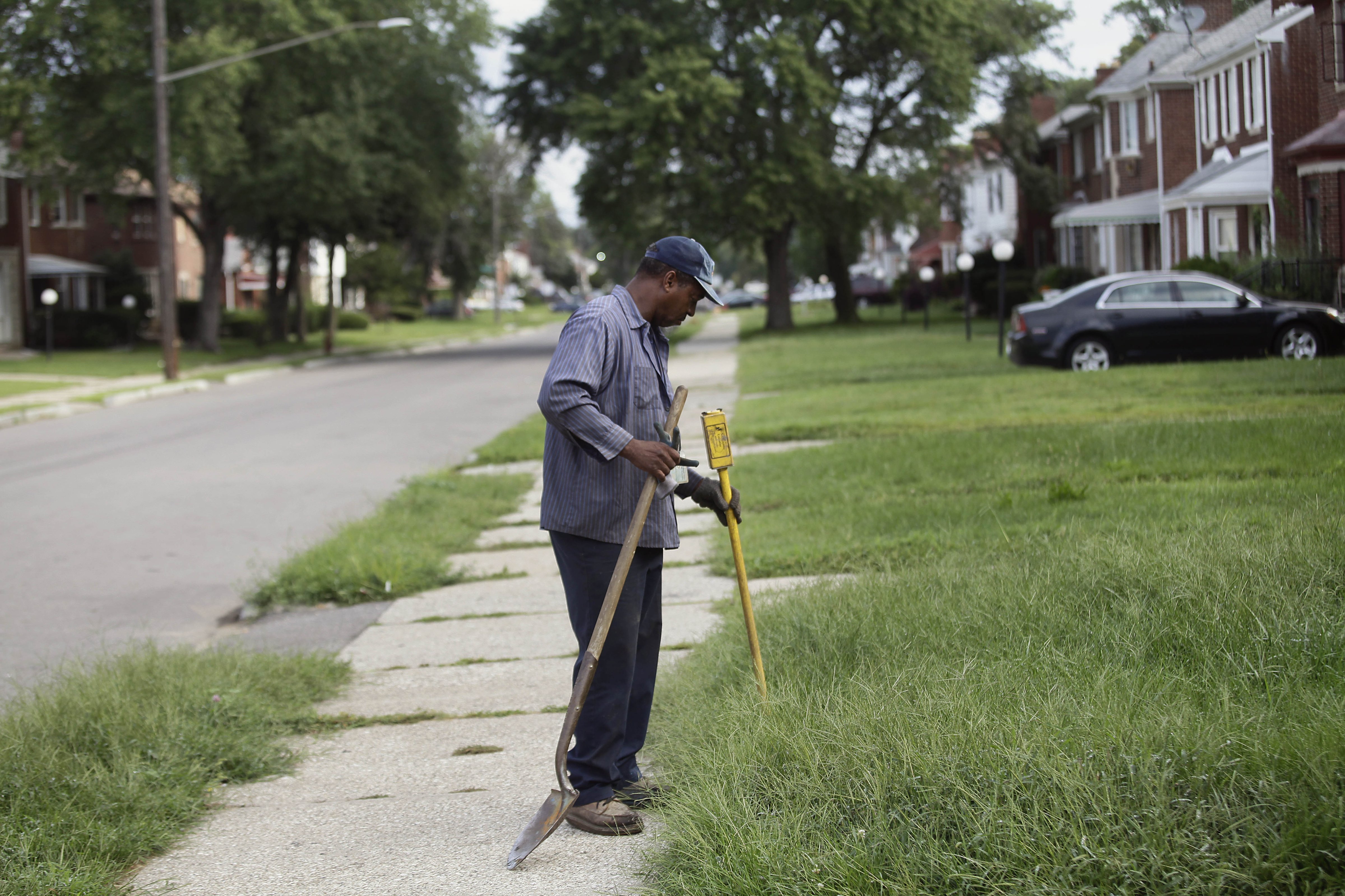 A worker from Homrich turns off water supply to a home August 27, 2014 in Detroit, Michigan. The Detroit Water and Sewer Department have disconnected water to thousands of Detroit residents who are delinquent with their bills. (Joshua Lott&mdash;Getty Images)