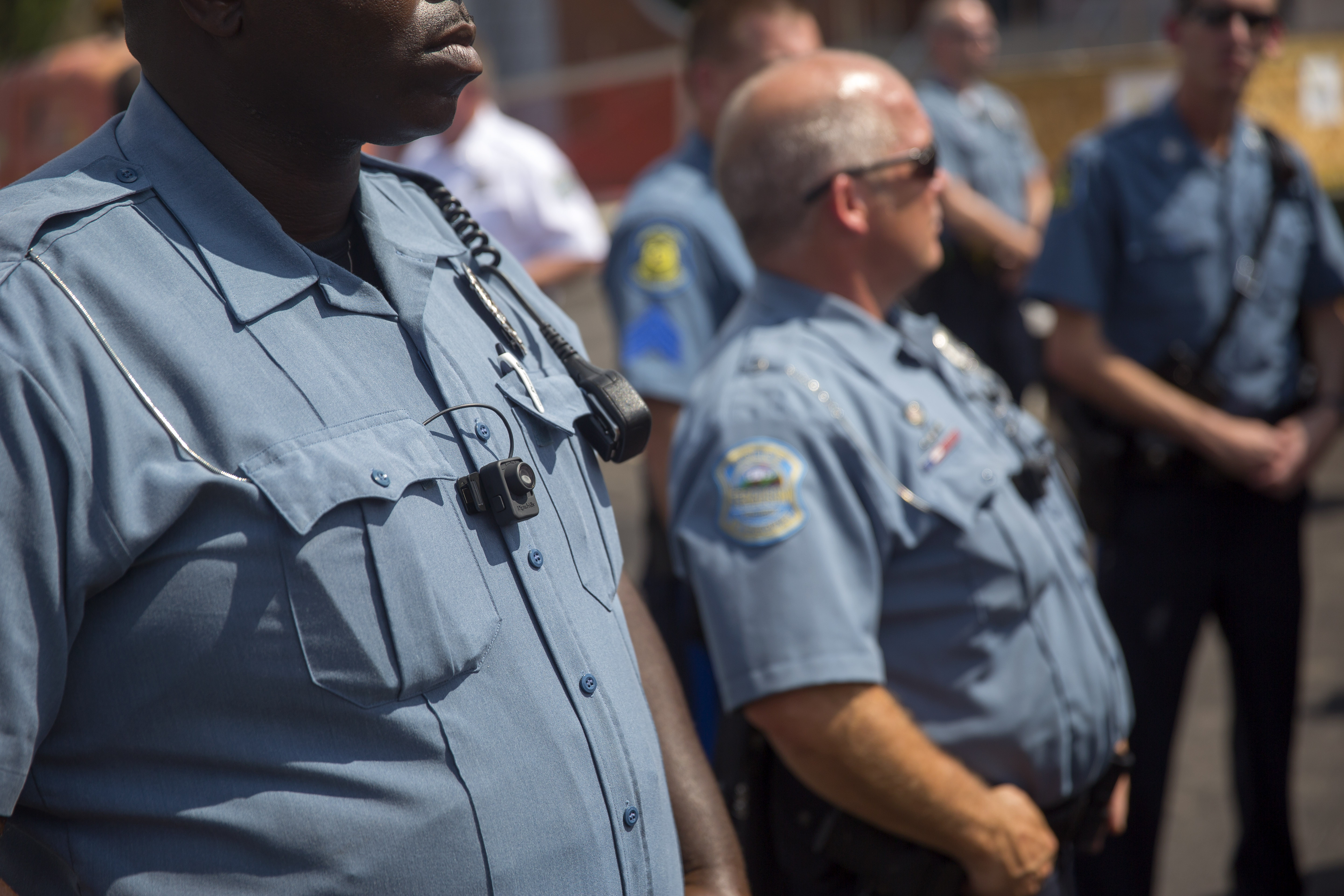 Members of the Ferguson Police Department wear body cameras during a rally on Aug. 30, 2014, in Ferguson. Like a number of departments around the U.S., Ferguson police began using  the wearable cameras after Michael Brown was killed. There are no video recordings of the incident involving Brown and officer Darren Wilson.