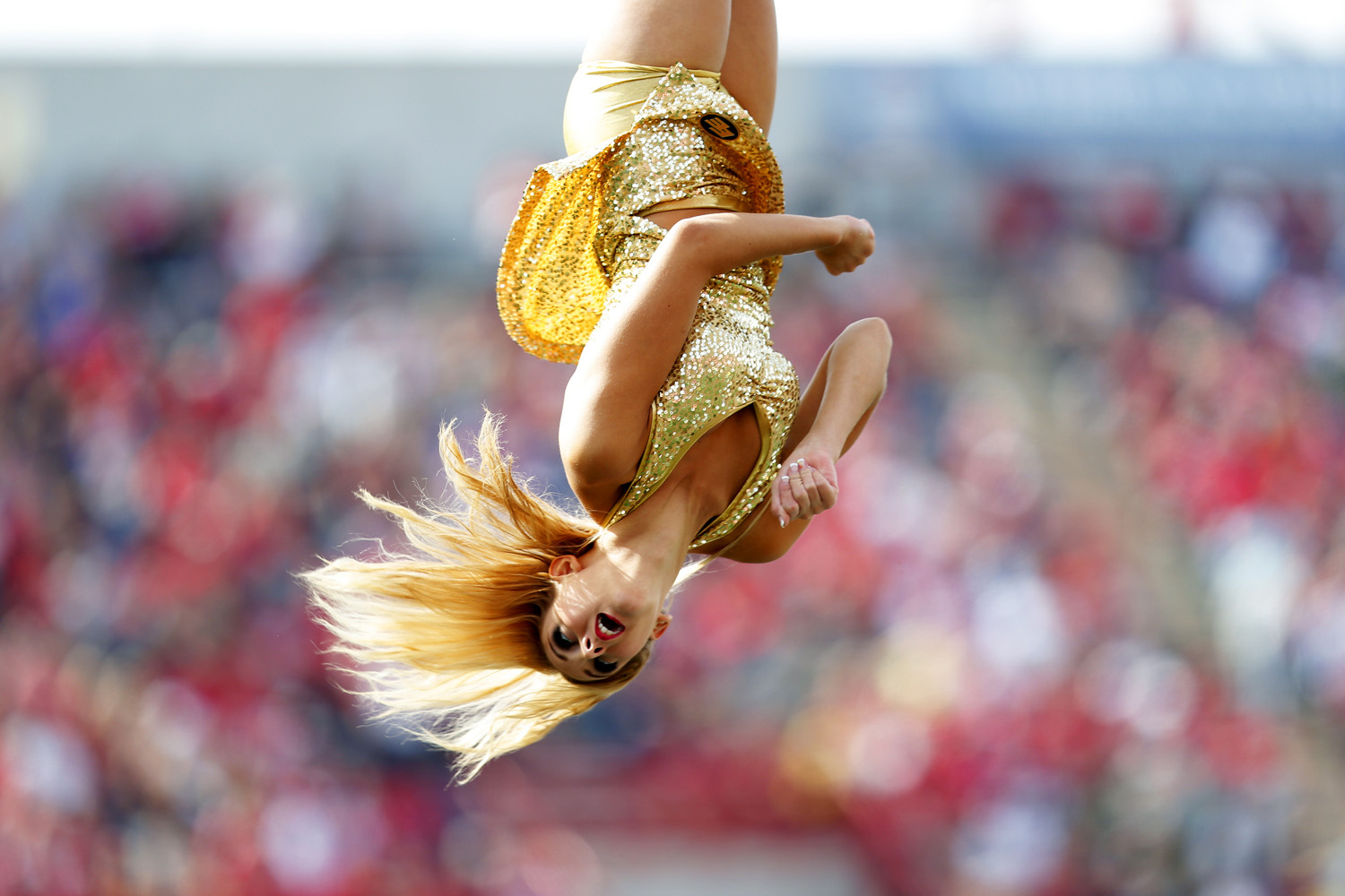 A cheerleader for the Edmonton Eskimos goes flying through the air while during the match against Calgary Stampeders in Calgary, Canada on Sept. 1, 2014.