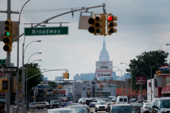 Vehicles drive past the Major Chrysler Jeep Dodge Ram dealership as the Empire State building stands in the background in the Queens borough of New York, U.S., on Monday, Sept. 1, 2014. Domestic and total vehicle sales figures are scheduled to be released on Sept. 3. Photographer: Craig Warga/Bloomberg via Getty Images (Bloomberg&mdash;Bloomberg via Getty Images)