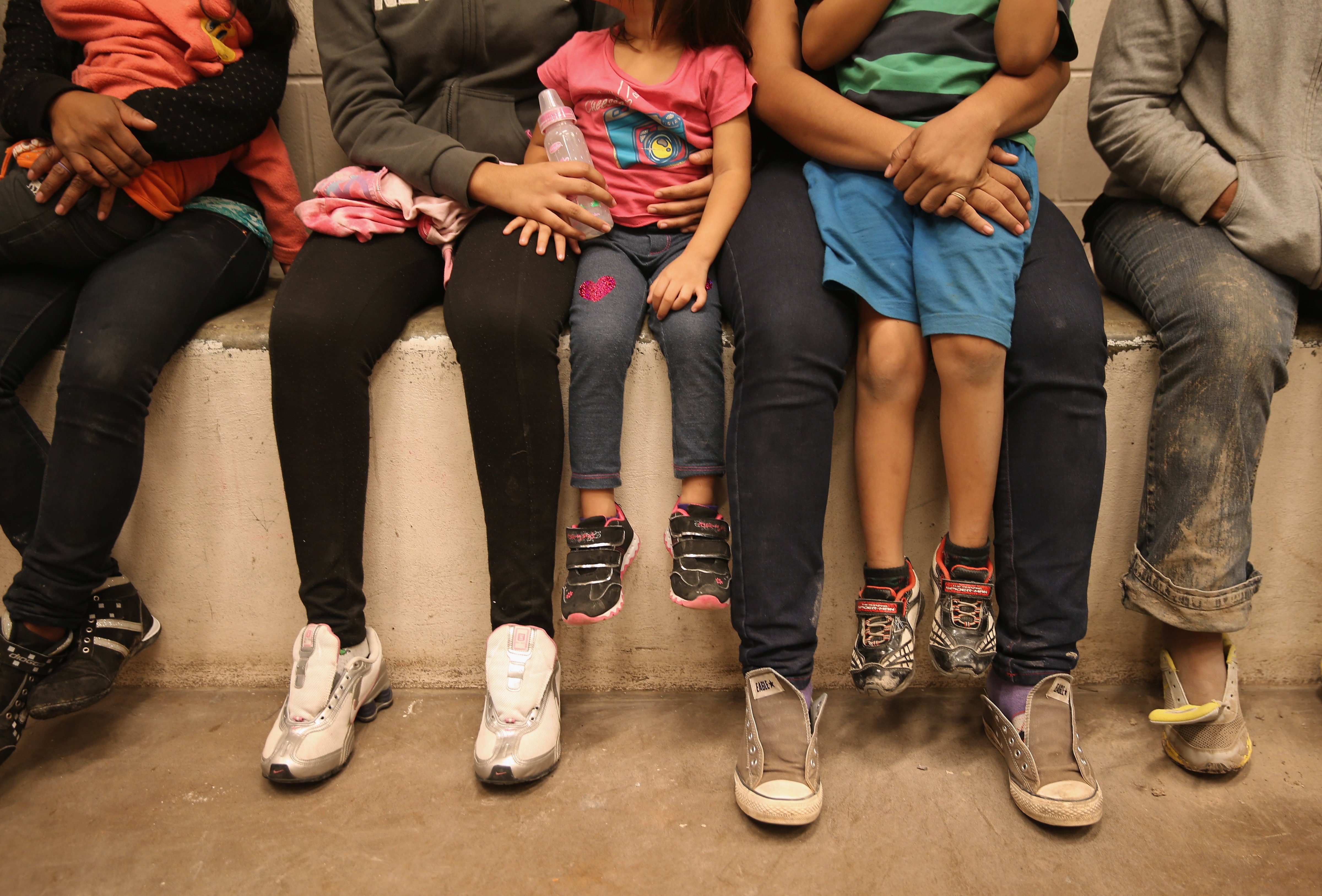 Women and children sit in a holding cell at a U.S. Border Patrol processing center after being detained by agents near the U.S.-Mexico border on September 8, 2014 near McAllen, Texas. (John Moore&mdash;Getty Images)