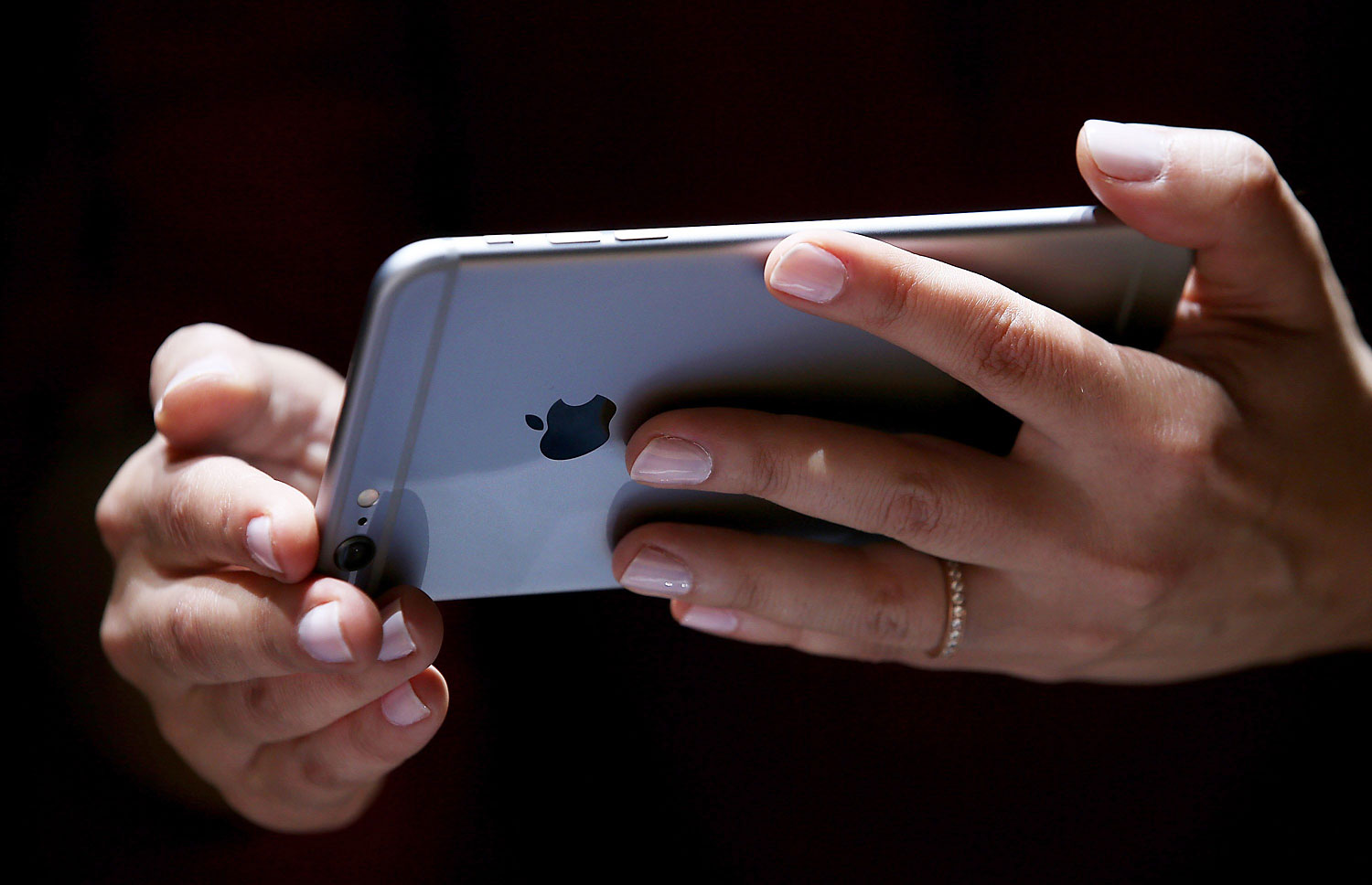 A member of the media inspects the new iPhone 6 during an Apple special event in Cupertino, Calif., on Sept. 9, 2014 (Justin Sullivan—Getty Images)