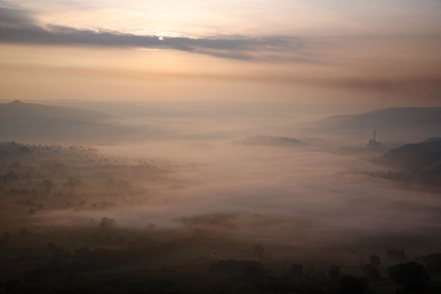 Sept. 10, 2014.  Mist lingers in Hope Valley at sunrise viewed from the top of Mam Tor in the Peak District in Castleton, United Kingdom. Much of the UK continues to enjoy mild Autumn weather with sunshine set to last for the next few days.