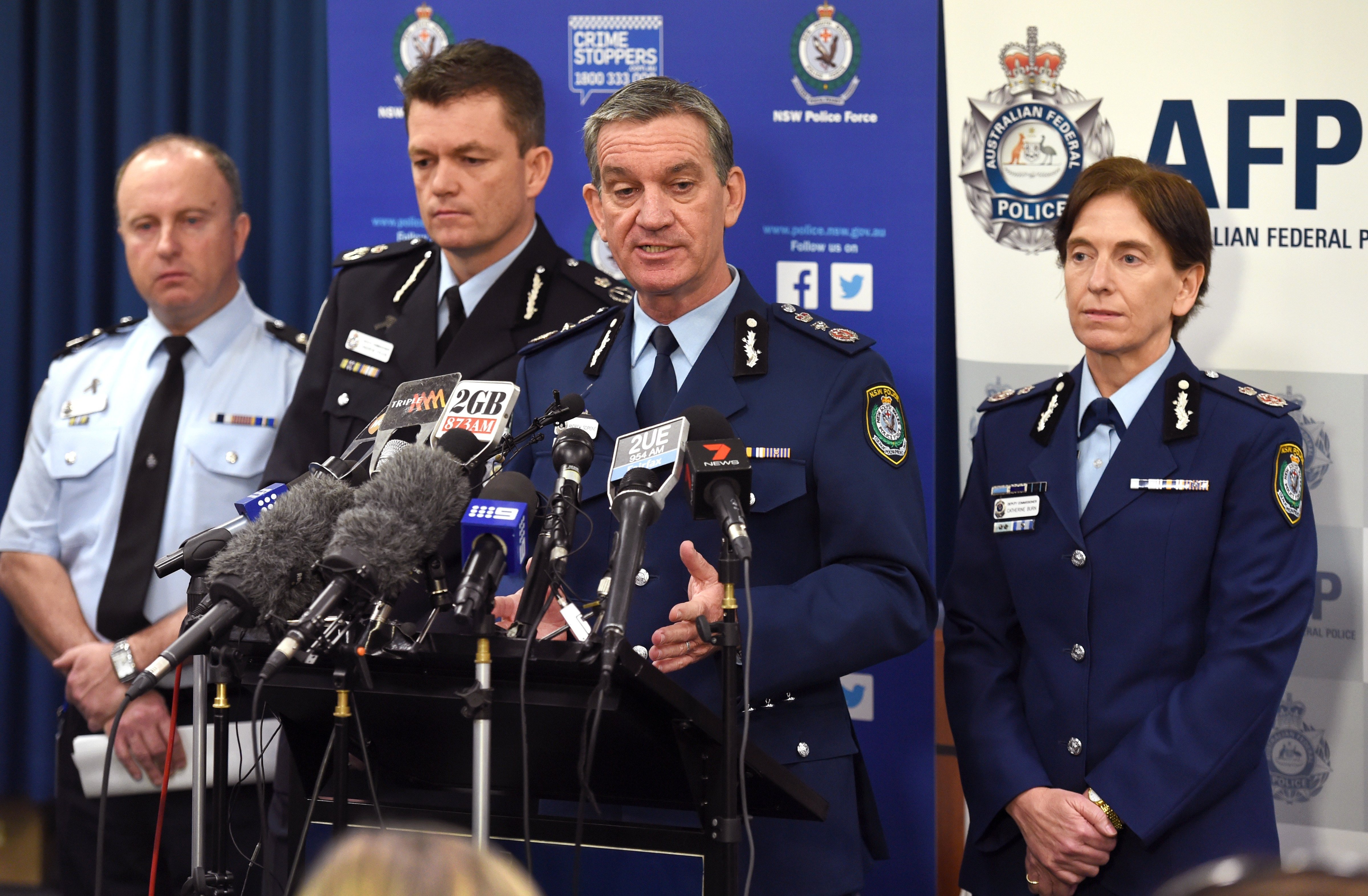 New South Wales police commissioner Andrew Scipione, second from right, speaks during a press conference in Sydney on Sept. 18, 2014, after Australia's largest ever counterterrorism raids detained 15 people and disrupted plans to "commit violent acts" (William West—AFP/Getty Images)