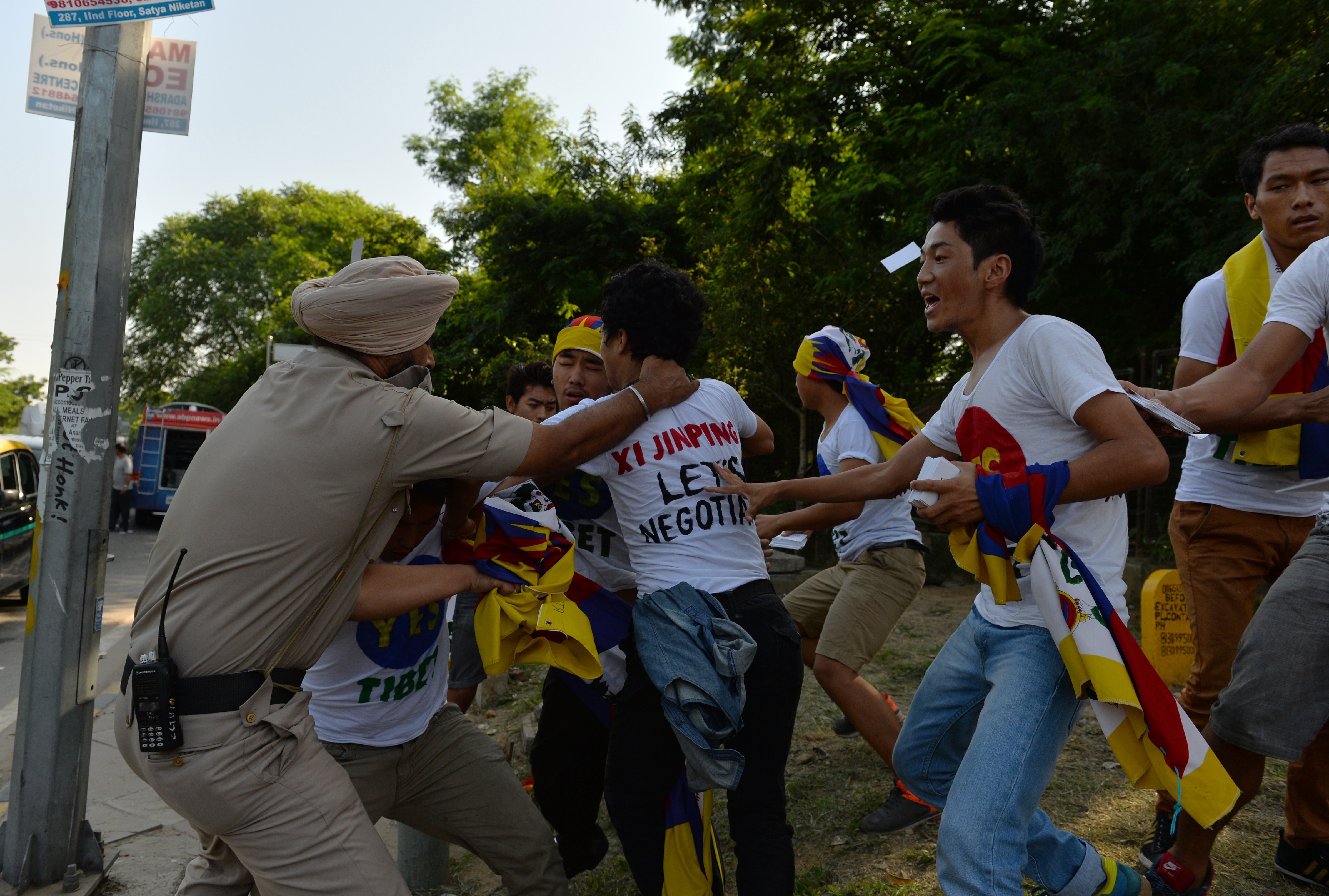 Indian police try to prevent exiled Tibetan youths from advancing as they protest against a visit to India by Chinese President Xi Jinping outside a hotel in New Delhi on Sept. 18, 2014 (Chandan Khanna—AFP/Getty Images)