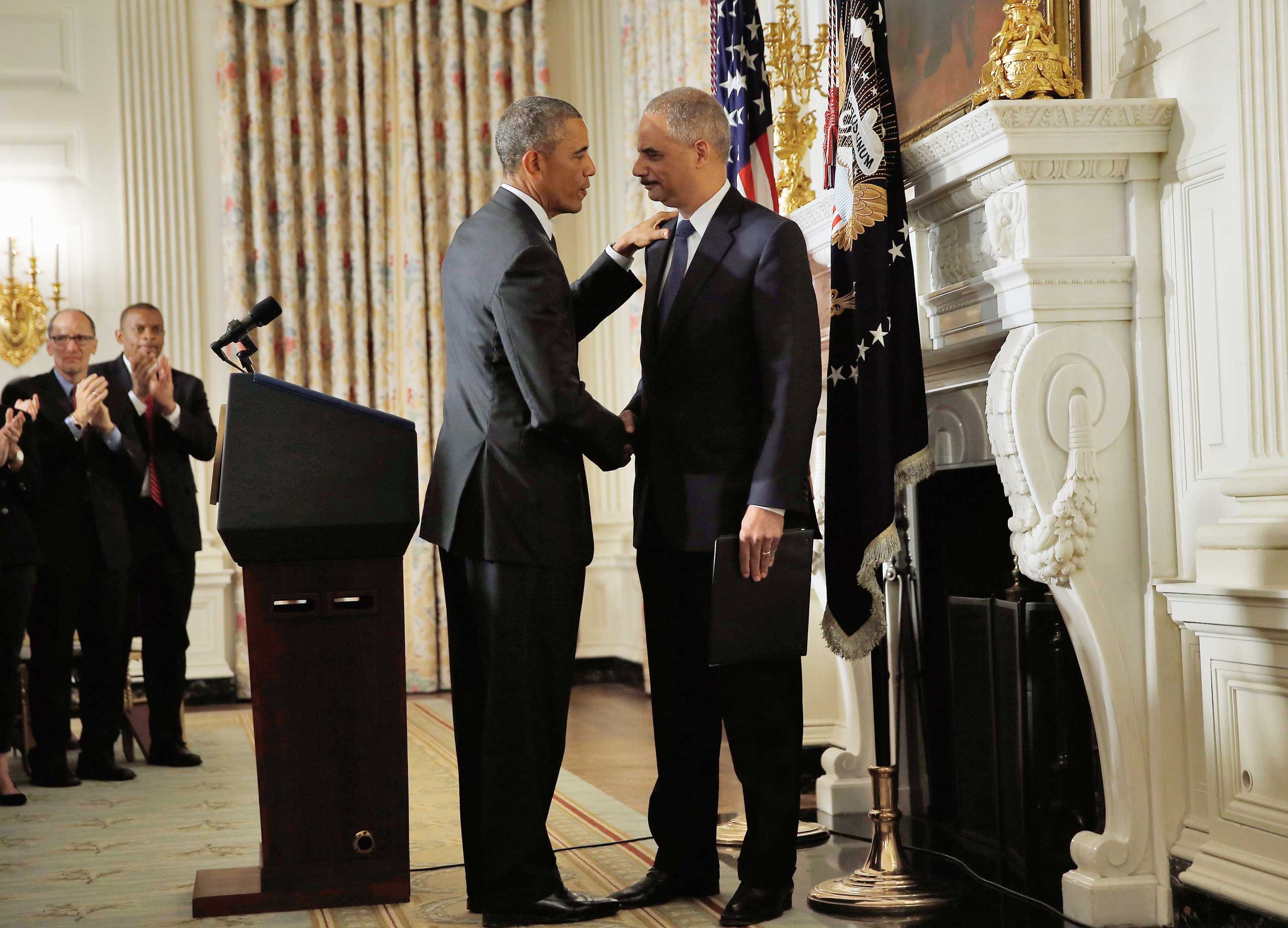 President Barack Obama shakes hands with Attorney General Eric H. Holder Jr. who announced his resignation today, Sept. 25, 2014 in Washington, DC. (Win McNamee—Getty Images)