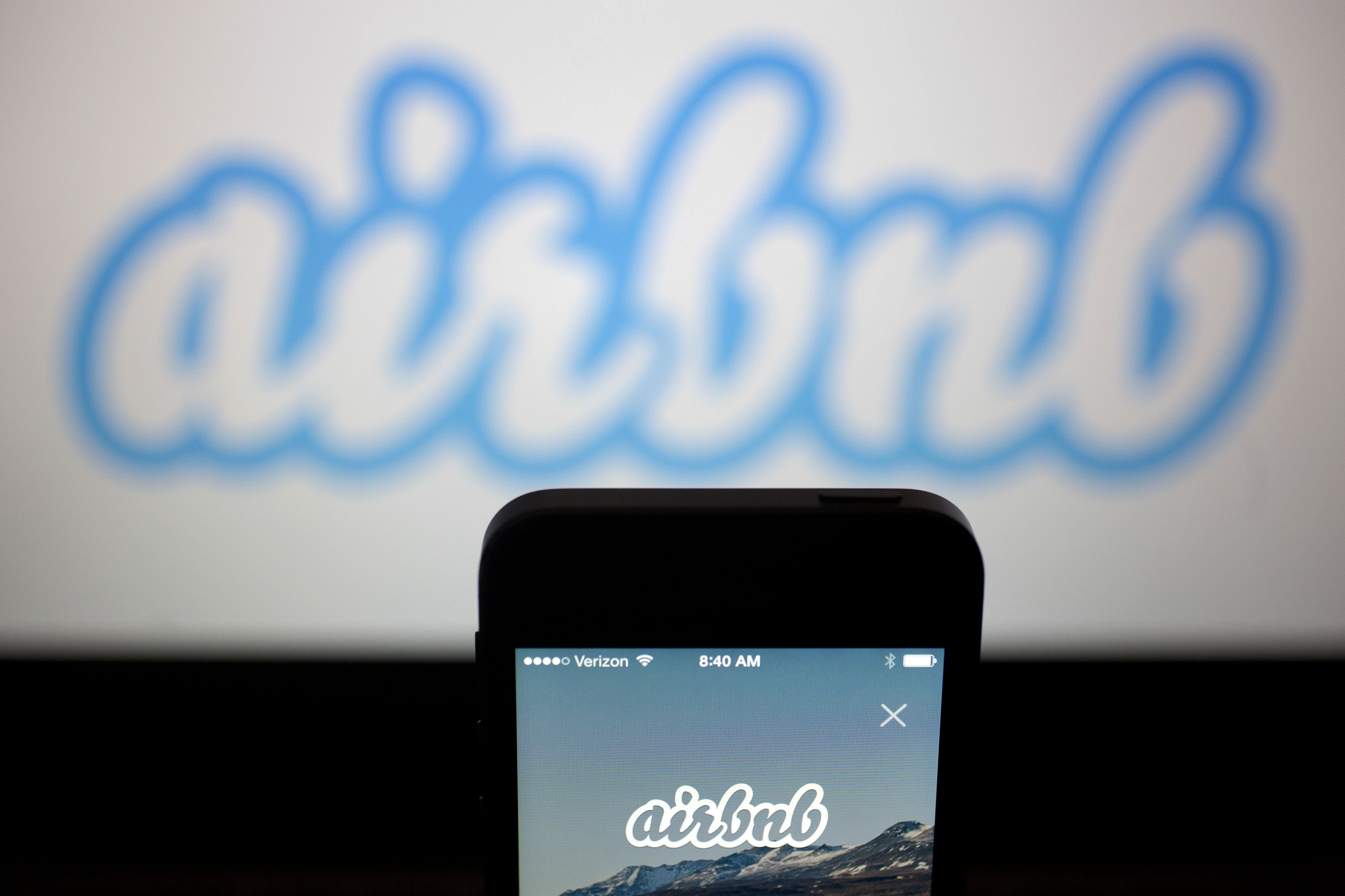The Airbnb application and logo are displayed on an Apple iPhone in this arranged photograph in Washington, D.C., on March 21, 2014 (Andrew Harrer—Bloomberg/Getty Images)