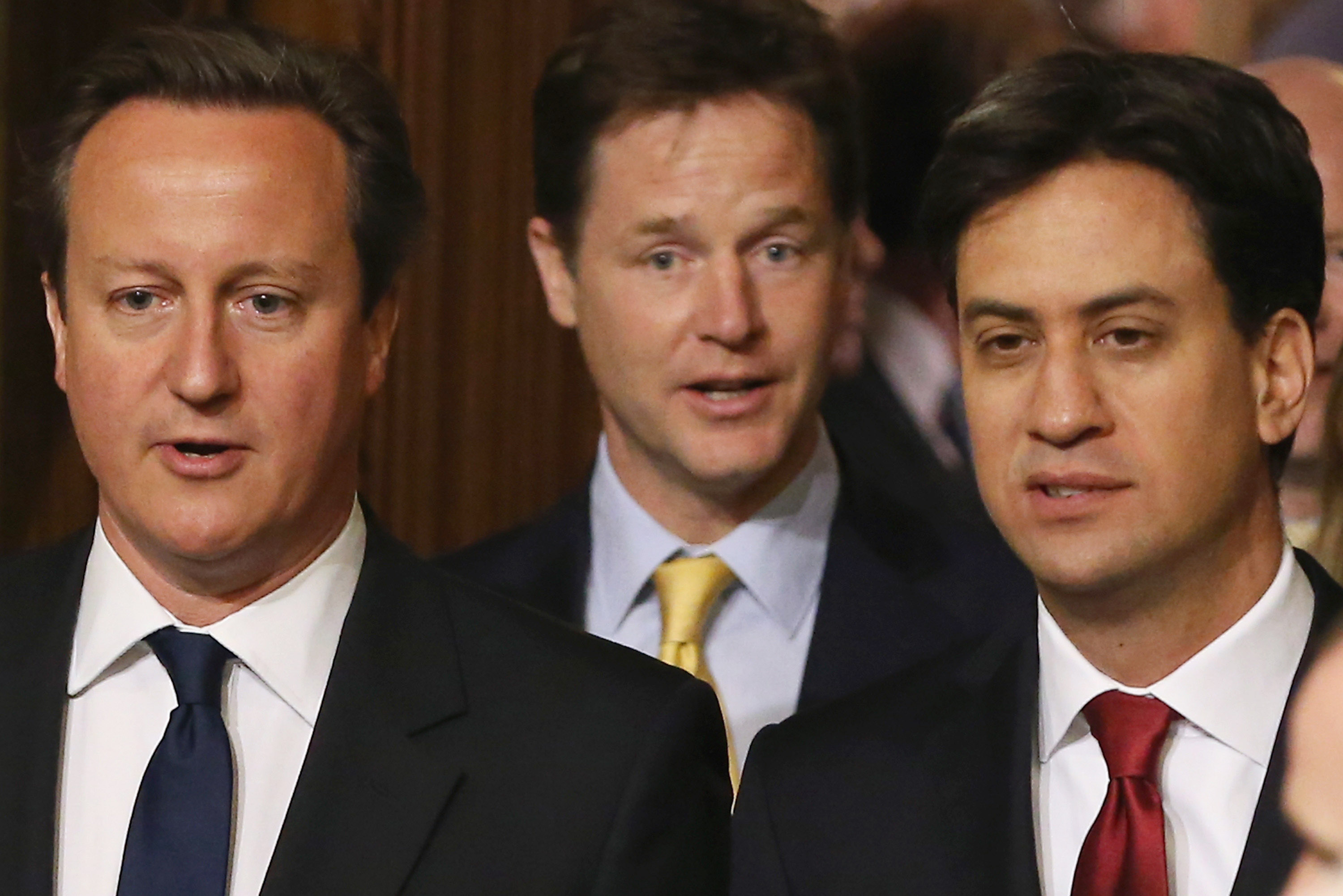 British Prime Minister David Cameron (L)  Deputy Prime Minister and leader of the Liberal Democrats Nick Clegg (C) Leader of the Labour Party Ed Miliband (R) walk through the Members' Lobby of Parliament  on June 4, 2014 in London, England. (Dan Kitwood—Getty Images)