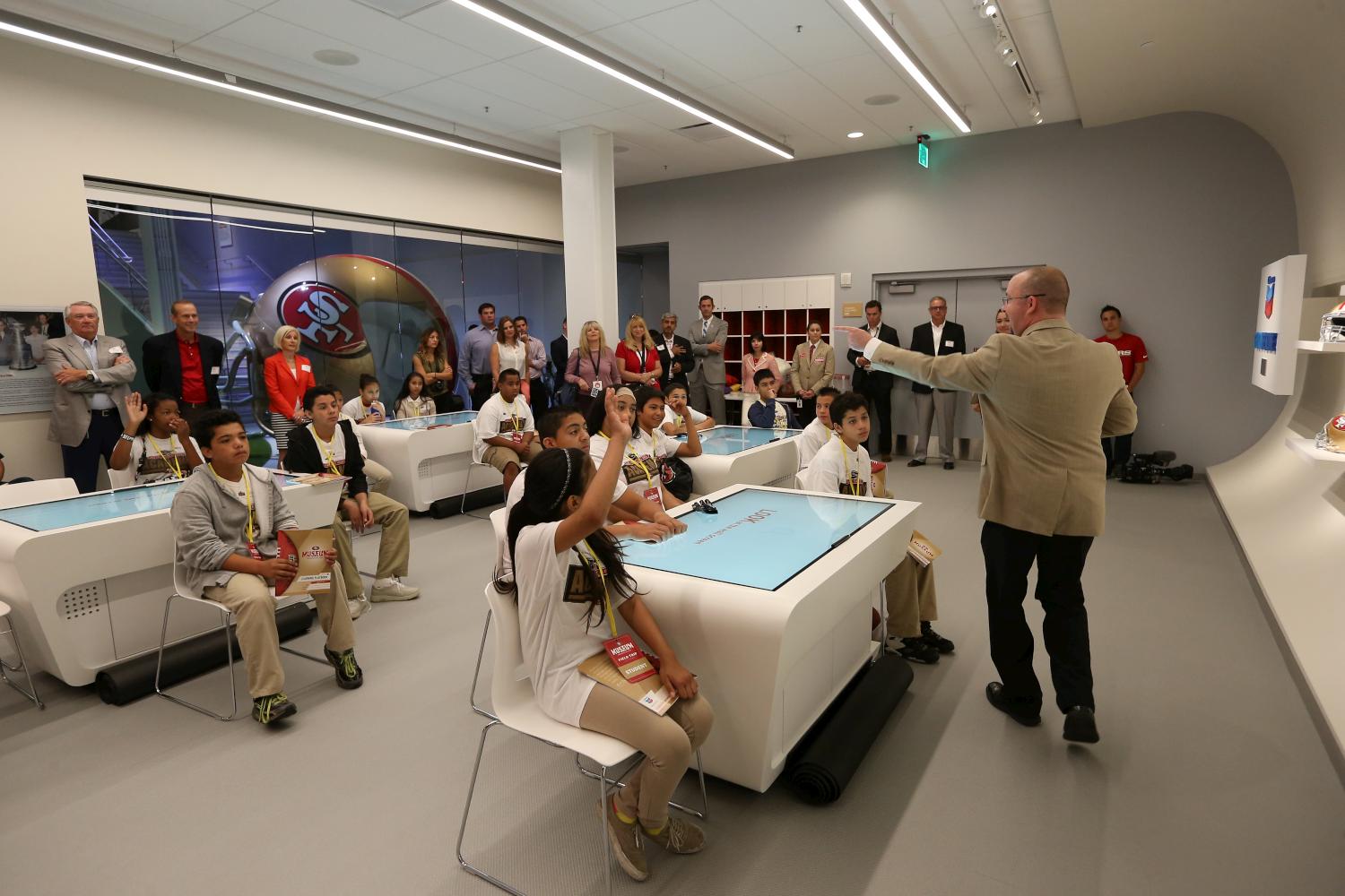 Students receive instructions from teacher Matt Van Dixon while sitting at interactive video tables made by Cortina Productions at the 49ers STEM Leadership Institute at Levi's Stadium (Terrell Lloyd / San Francisco 49ers)