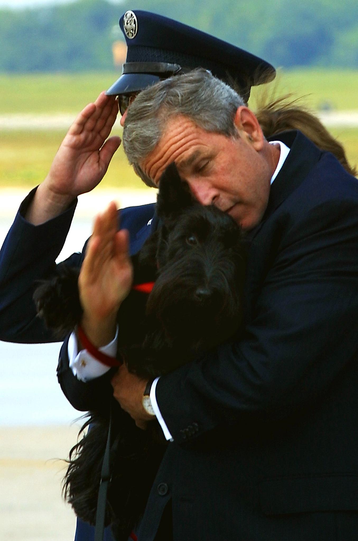 US President George W. Bush tries to salute the se
