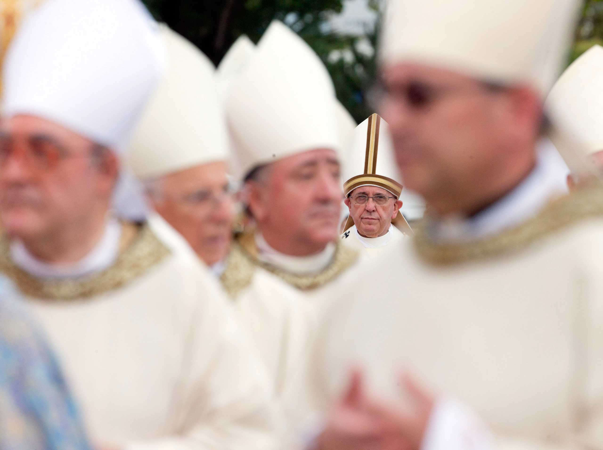 Sept. 21, 2014. Pope Francis is framed by prelates as he arrives for a Mass in Mother Teresa Square in Tirana, Albania.