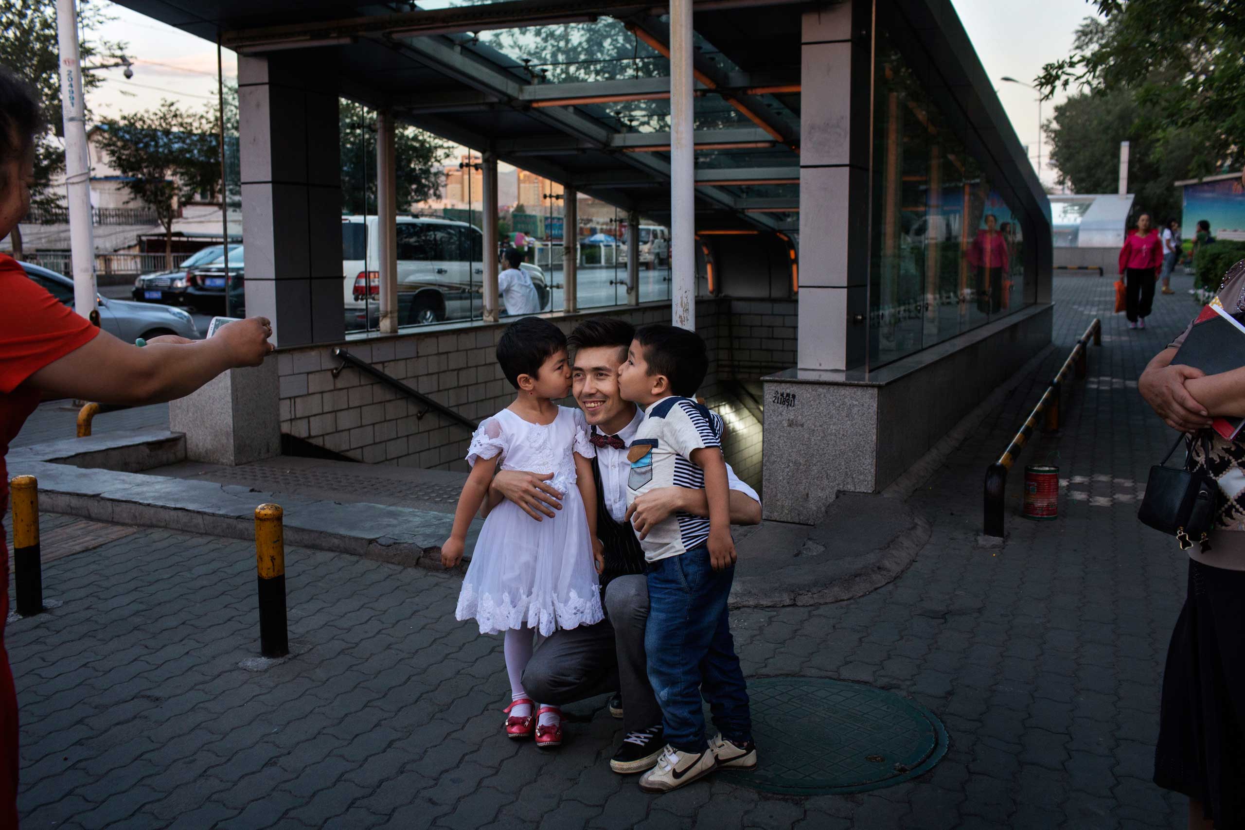 A fan photographs Ablajan with her young relatives after the cancellation of a planned live webcast concert scheduled for that afternoon in Urumqi, China on July 31, 2014.