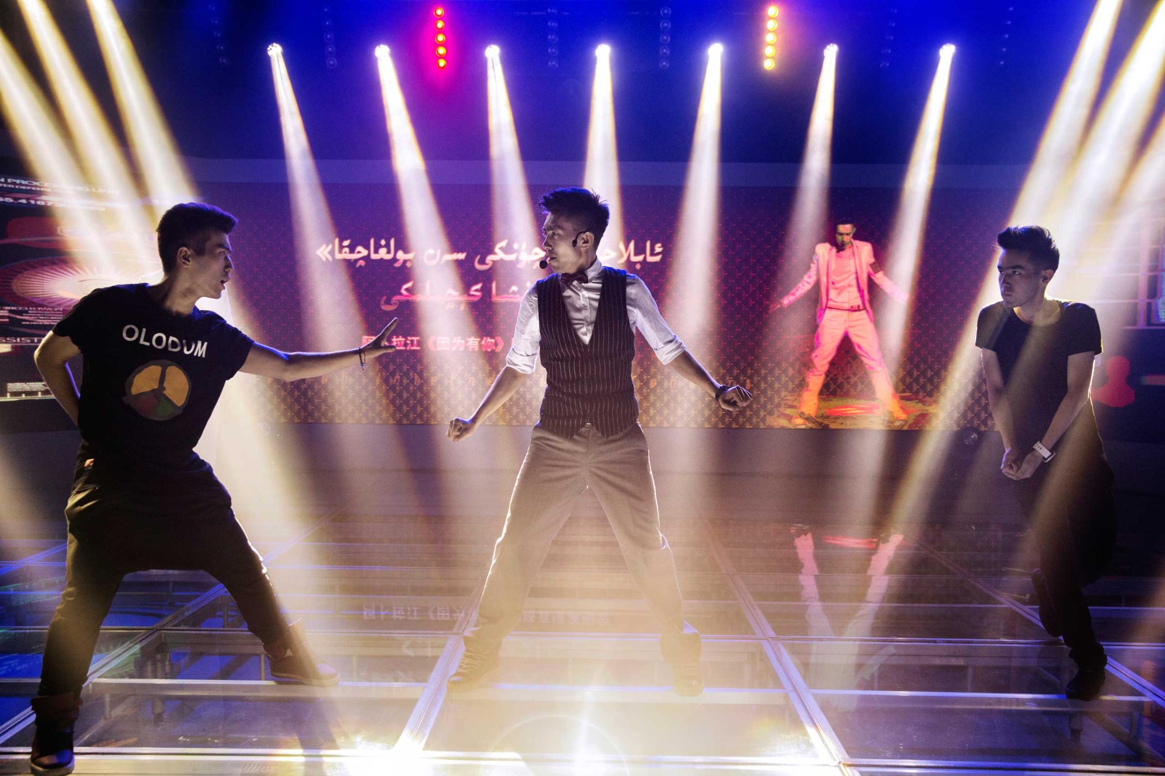 Ablajan performs on stage with his dancers at rehearsals for a planned live webcast concert scheduled for that afternoon in Urumqi, China on July 31st, 2014.