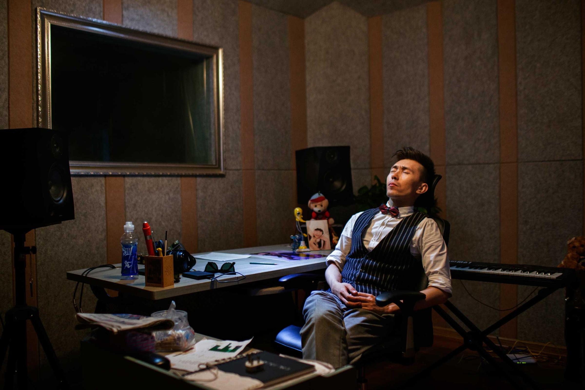 A frustrated and disappointed Ablajan sits at his studio after the cancellation of a planned live webcast concert scheduled for that afternoon in Urumqi, China on July 31, 2014.