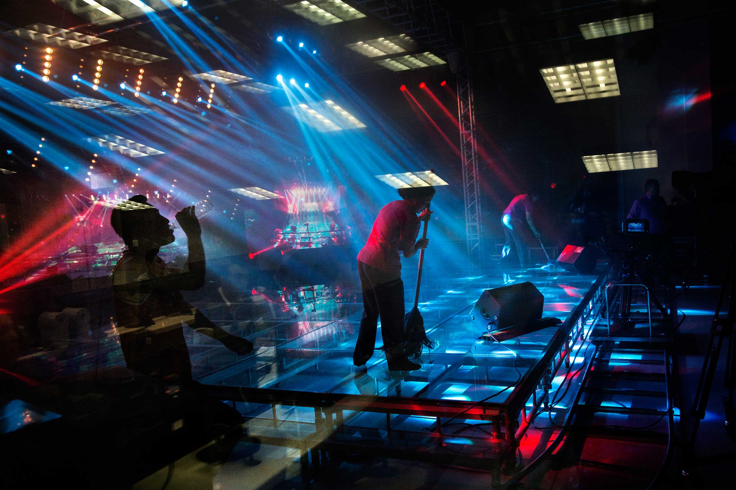 The crew of Uighur pop sensation Ablajan clean the stage during rehearsals for a planned live webcast concert scheduled for that afternoon in Urumqi, China, on July 31, 2014