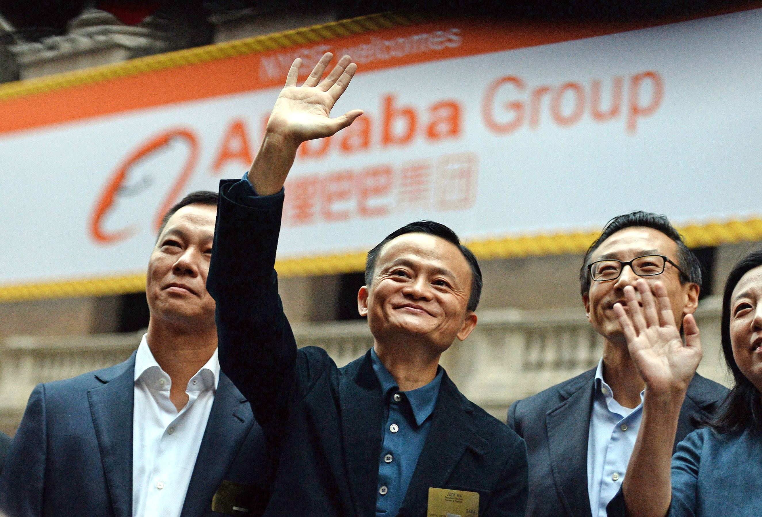 Chinese online retail giant Alibaba CEO Jack Ma (center) waves as he arrives at the New York Stock Exchange in New York City on Sept. 19, 2014.