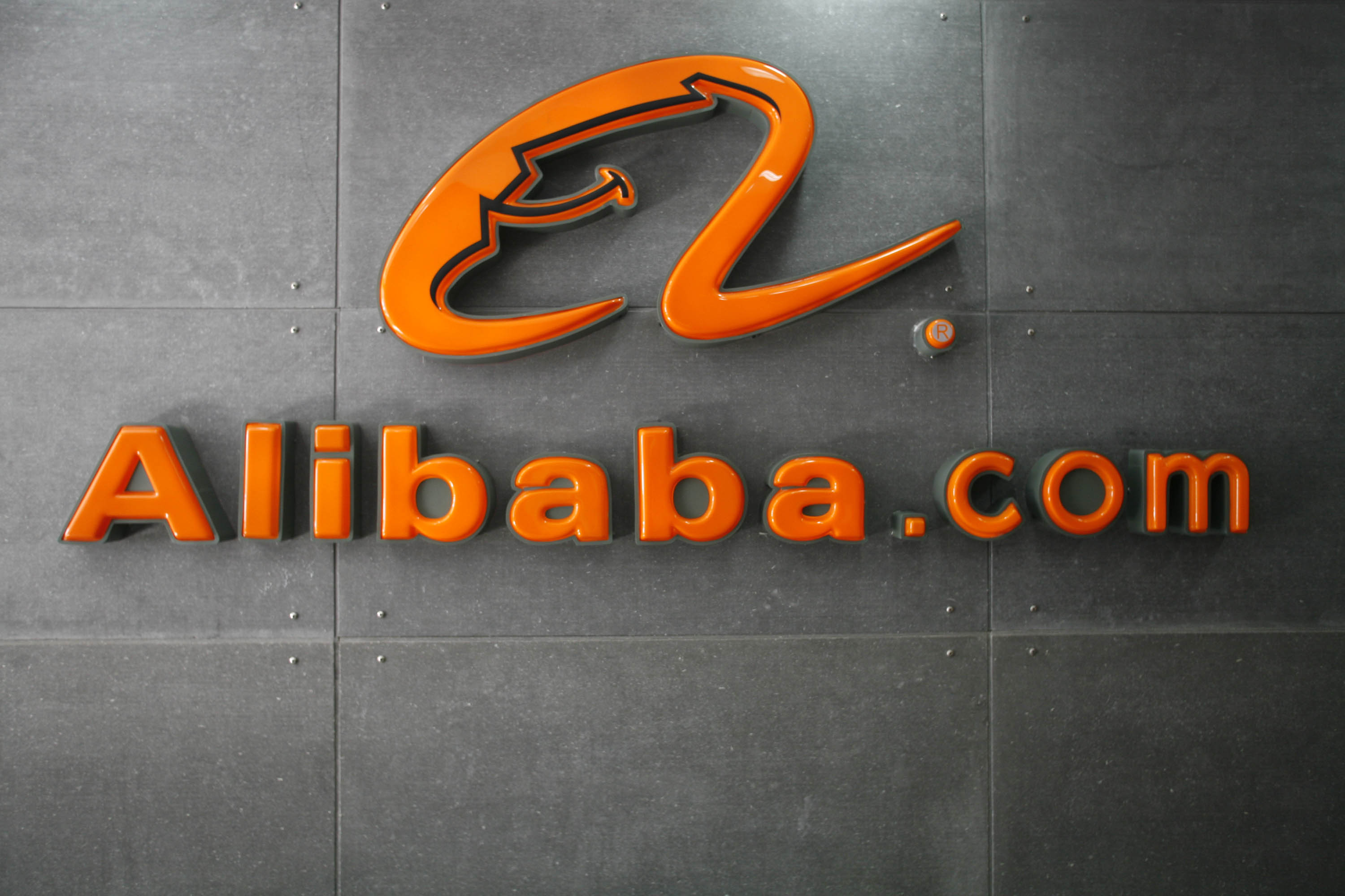 A logo hangs on the wall at the Alibaba.com head office in Hangzhou, China. (Bloomberg via Getty Images)