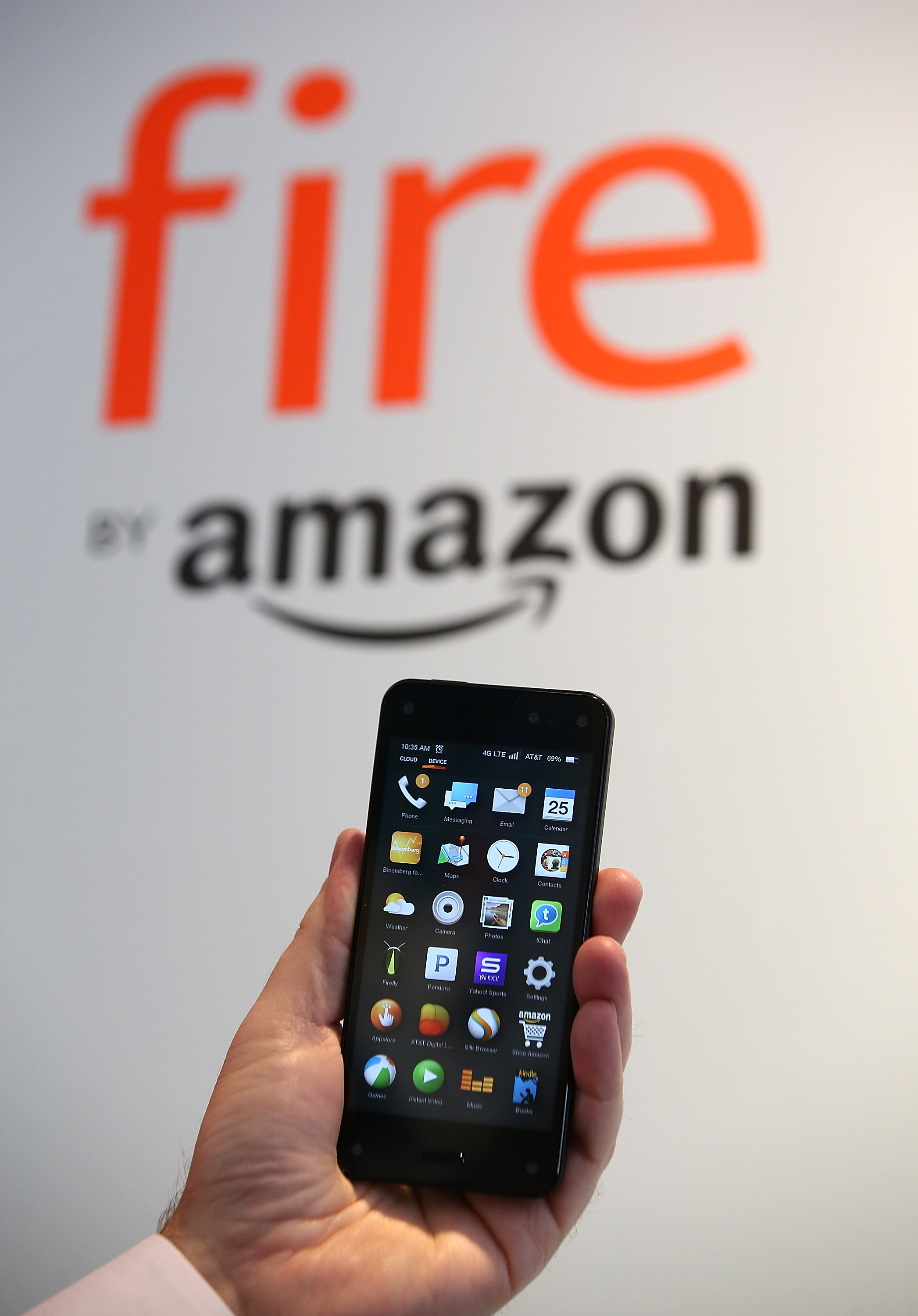 AN AT&T worker holds the new Amazon Fire phone at an AT&T store on July 25, 2014 in San Francisco.