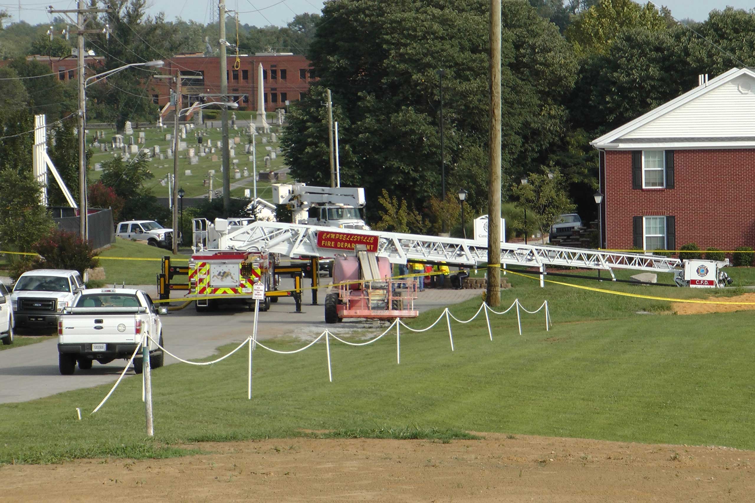 A Campbellsville Fire Department truck with the ladder extended remained at the scene where two firefighters were injured during an ice bucket challenge during a fundraiser for ALS on Thursday, Aug. 21, 2014, in Campbellsville, Ky. (Dylan Lovan&mdash;AP)