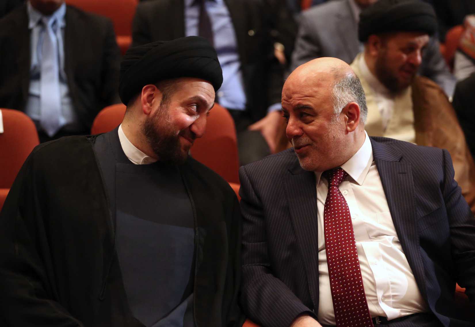 Iraq's new Prime Minister Haider al-Abadi, right, and Ammar al-Hakim, left, the leader of the Supreme Islamic Council of Iraq, during the session to approve the new government in Baghdad on Sept. 8, 2014 (Hadi Mizban—AP)
