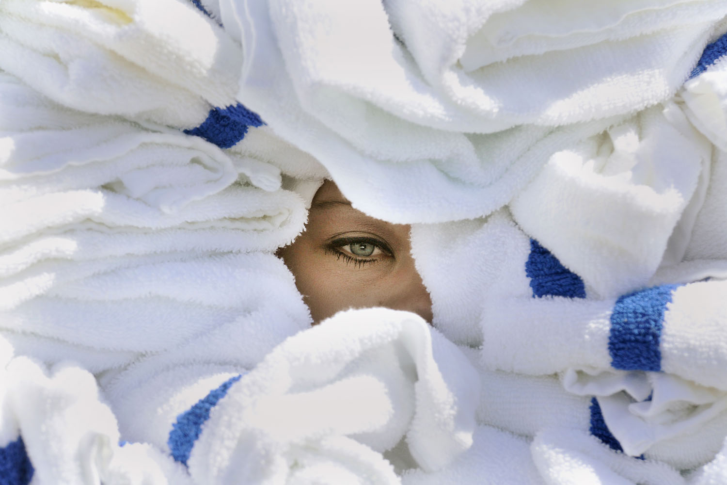 Sept. 8, 2014. Rebecca Redwine from Grandma's in the Park has one eye visible from between nearly 100 towels as she competes in the towel carrying contest during the 10th annual Iron Range Housekeeping Olympics held Monday at AmericInn in Virginia, Minn.