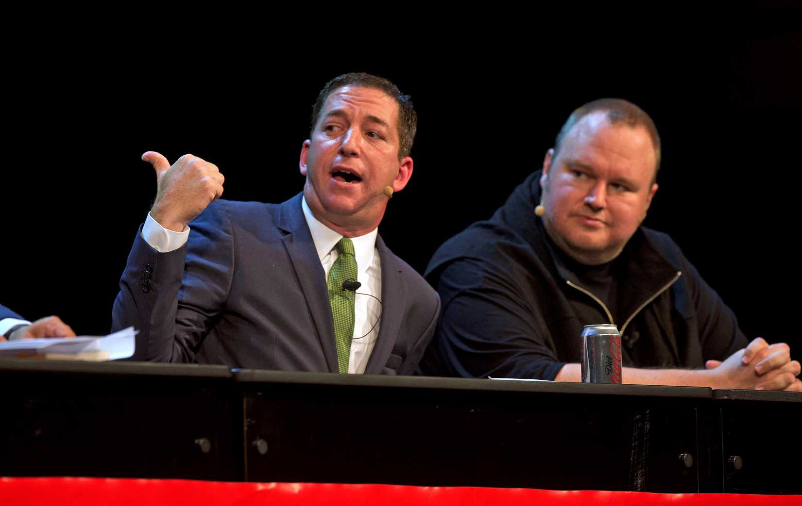Journalist and author Glenn Greenwald, left, and Kim Dotcom attend a political forum at in Auckland on Sept. 15, 2014 (Brett Phibbs—New Zealand Herald/AP)