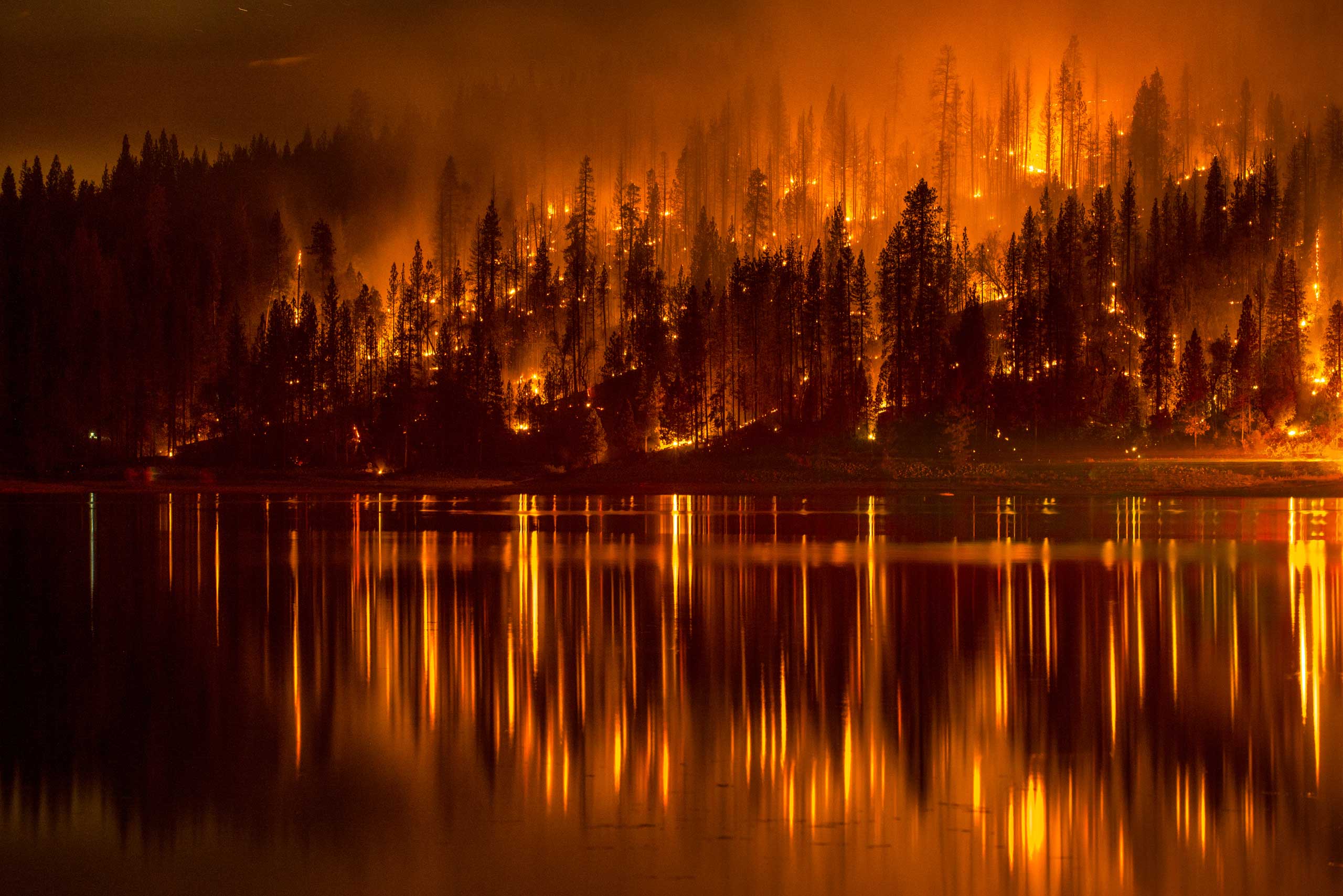 Sept. 14, 2014. A fire approaches the shore of Bass Lake, Calif.,