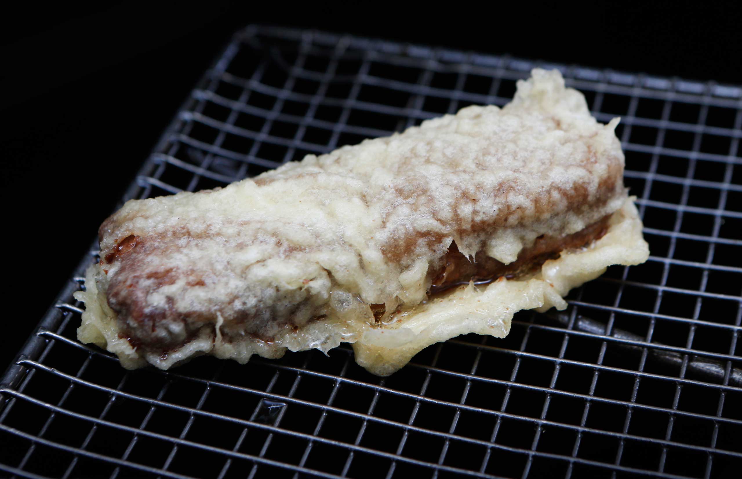 Food in Scotland. A deep fried Mars bar is prepared in a Glasgow chip shop ahead of the Glasgow 2014 Commonwealth Games. Picture date: Monday April 7, 2014. Photo credit should read: Danny Lawson/PA Wire URN:19505513 (Danny Lawson—PA Wire/Press Association Images/AP)