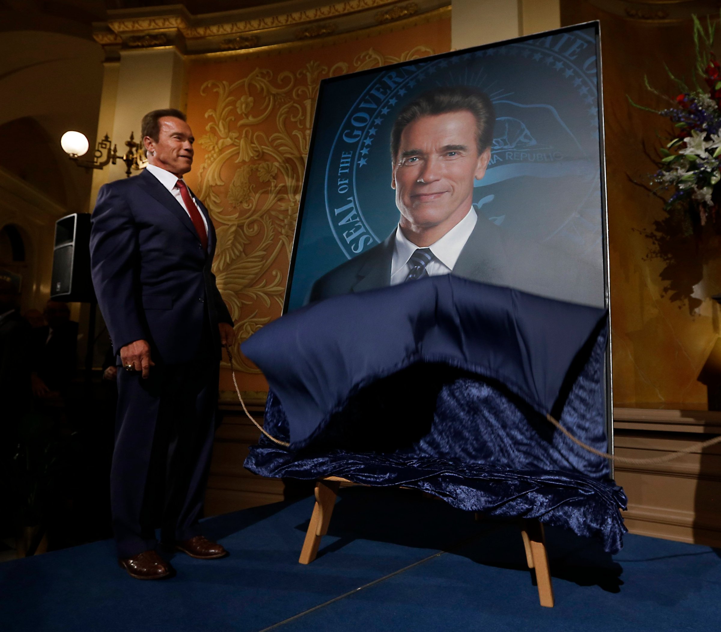 Former Gov. Arnold Schwarzenegger unveil's his official portrait during ceremonies at the Capitol in Sacramento, Calif. on Sept. 8, 2014.
