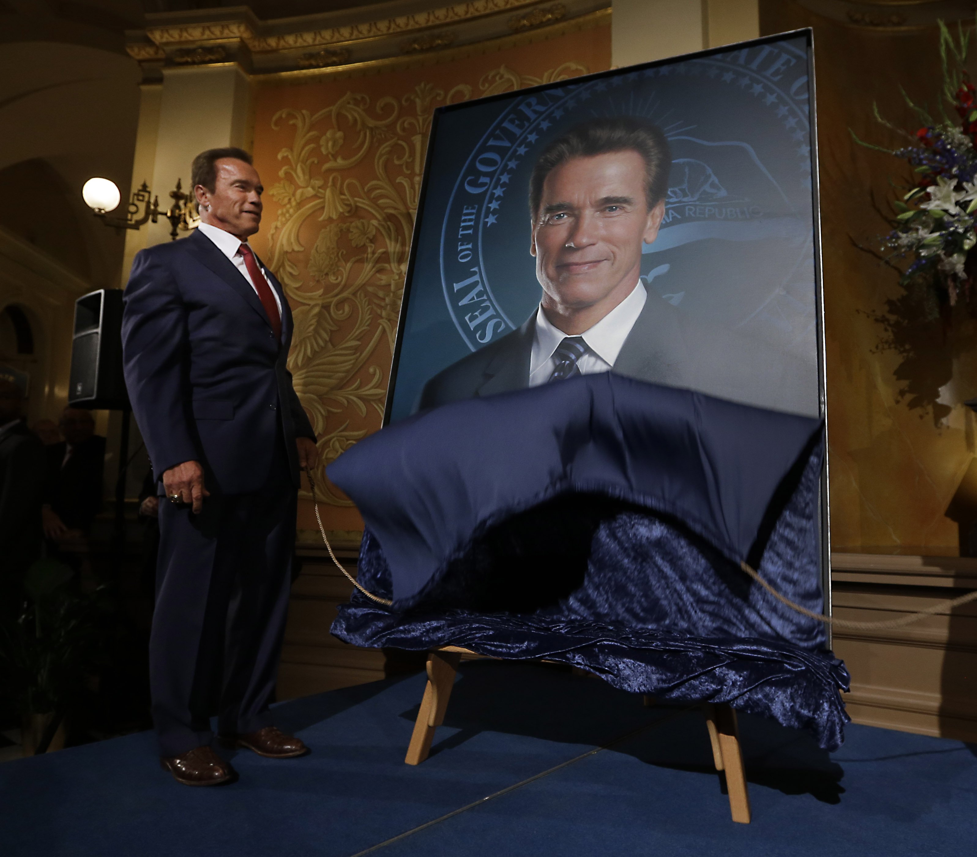 Former Gov. Arnold Schwarzenegger unveil's his official portrait during ceremonies at the Capitol in Sacramento, Calif. on Sept. 8, 2014.  