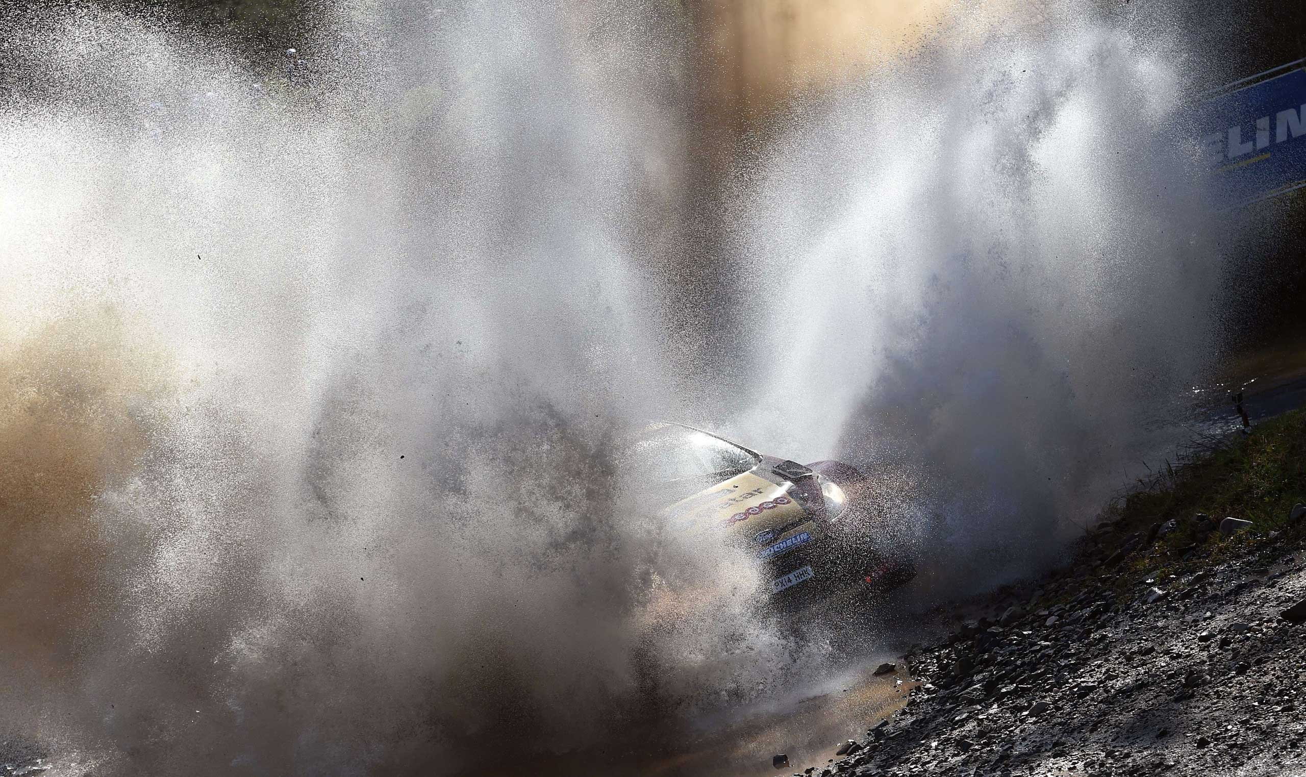 Sept. 14, 2014. Qatar's Nasser al-Attiyah powers through a water crossing in a Ford on the final day of the Rally of Australia, near Lowanna, Australia.
