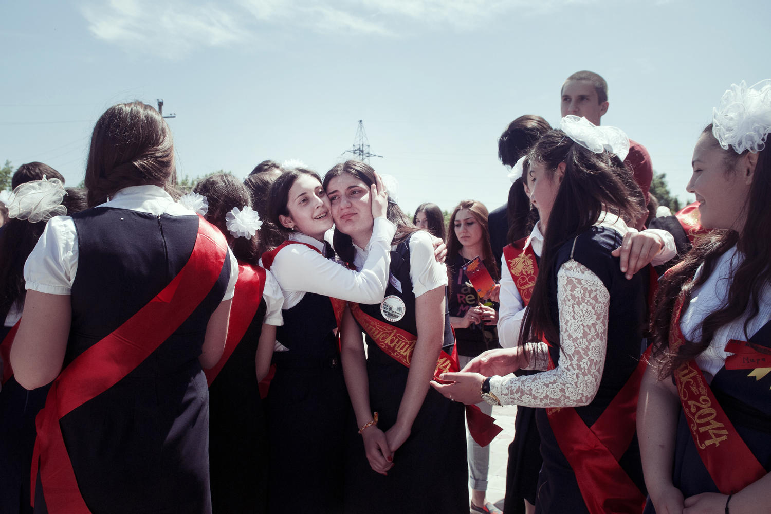 Graduates hugging each other during the graduation ceremony. Beslan. May 2014.