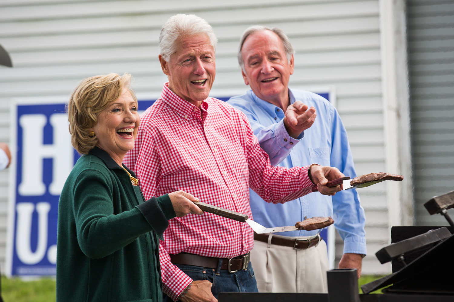 Hillary and Bill Clinton cook steaks with Iowa Senator Tom Harken at his annual Steak Fry in Indianola,  Iowa