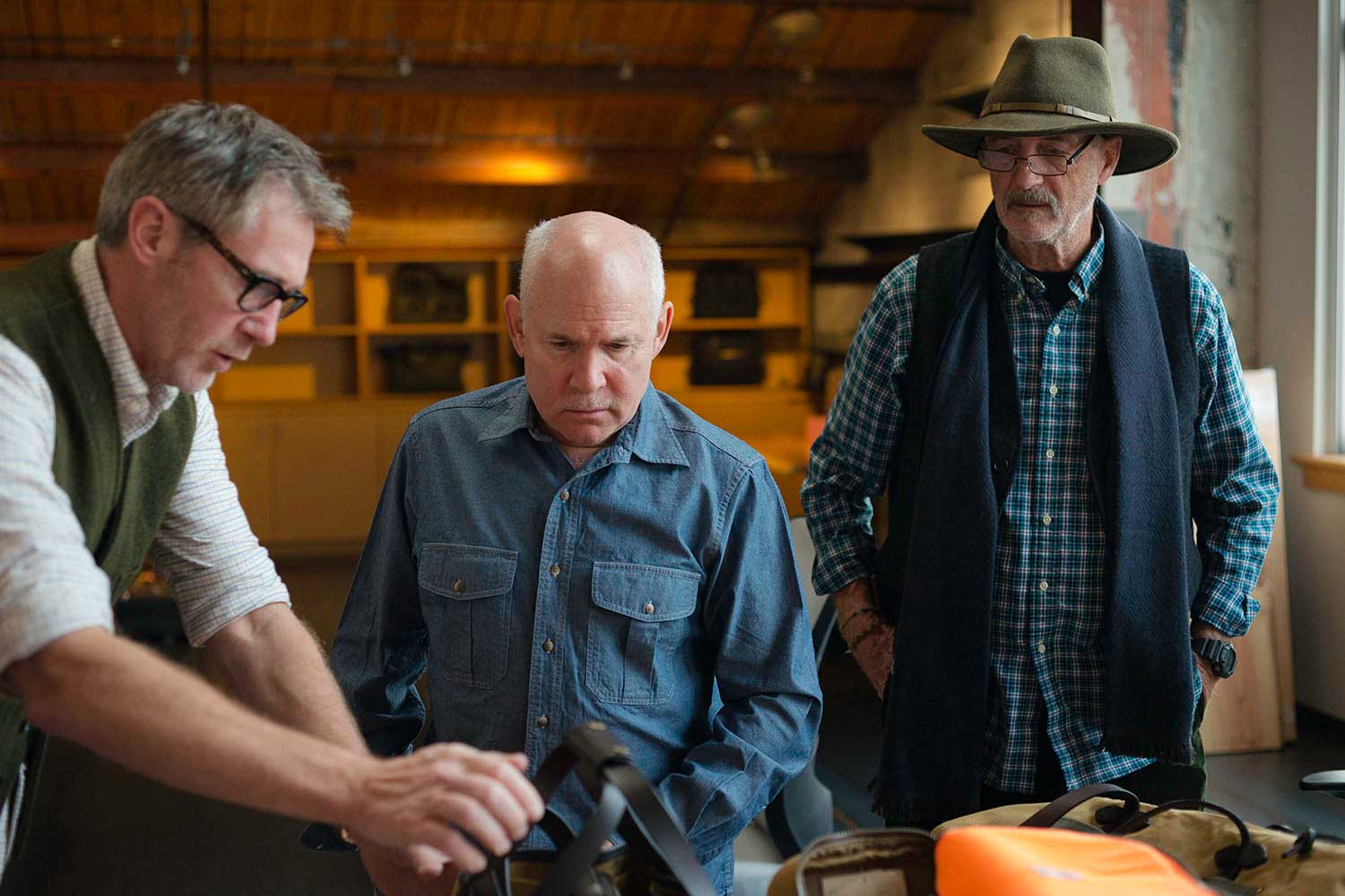 (L to R) CEO Alan Kirk and Magnum photographers Steve McCurry and David Alan Harvey at the headquarters in Seattle during the initial design process for the new line of camera bags being launched on May 1, 2014. (Filson)