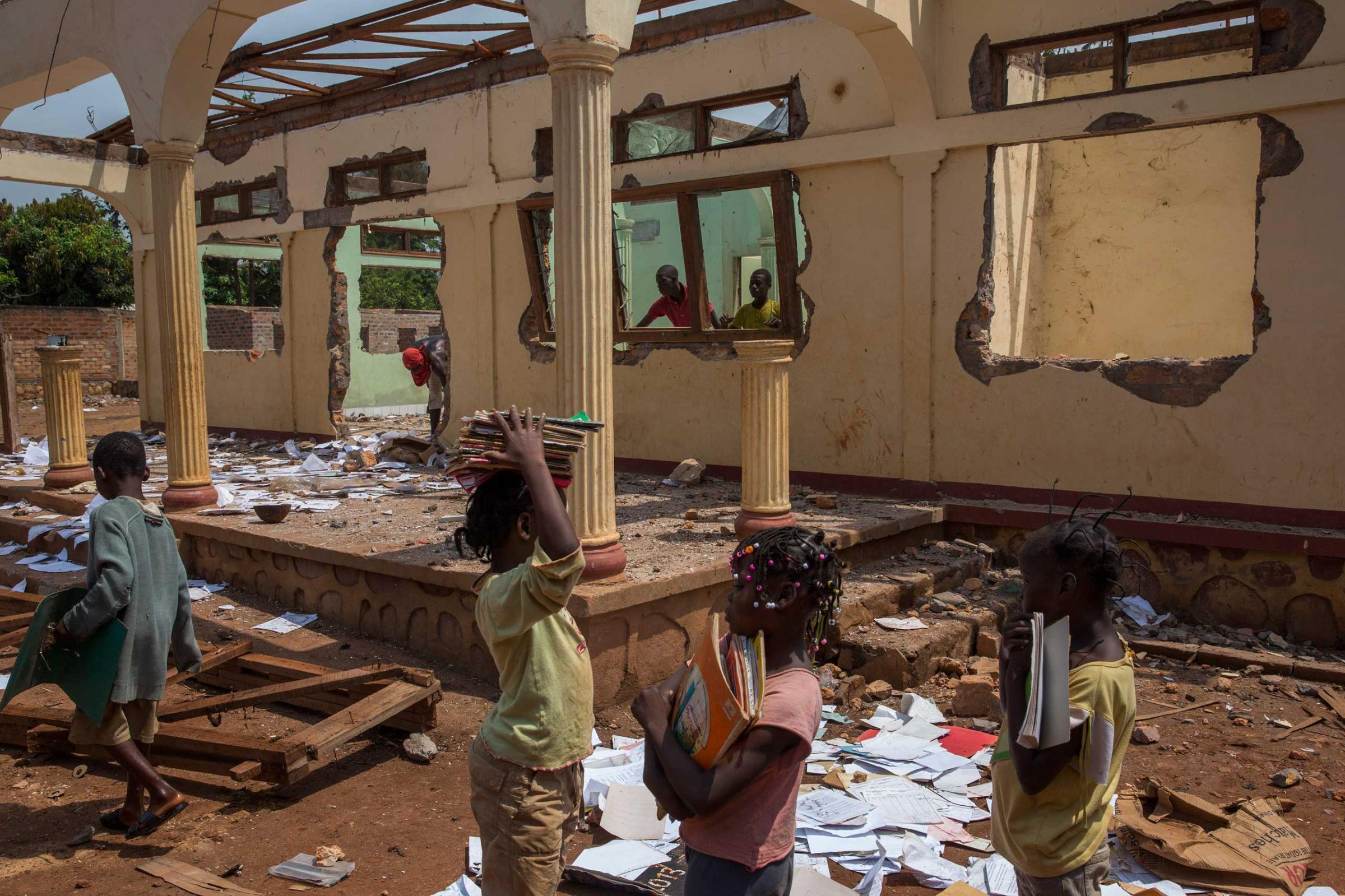 Feb. 3, 2014: Christian girls collect notebooks at a looted Muslim house in Bangui.