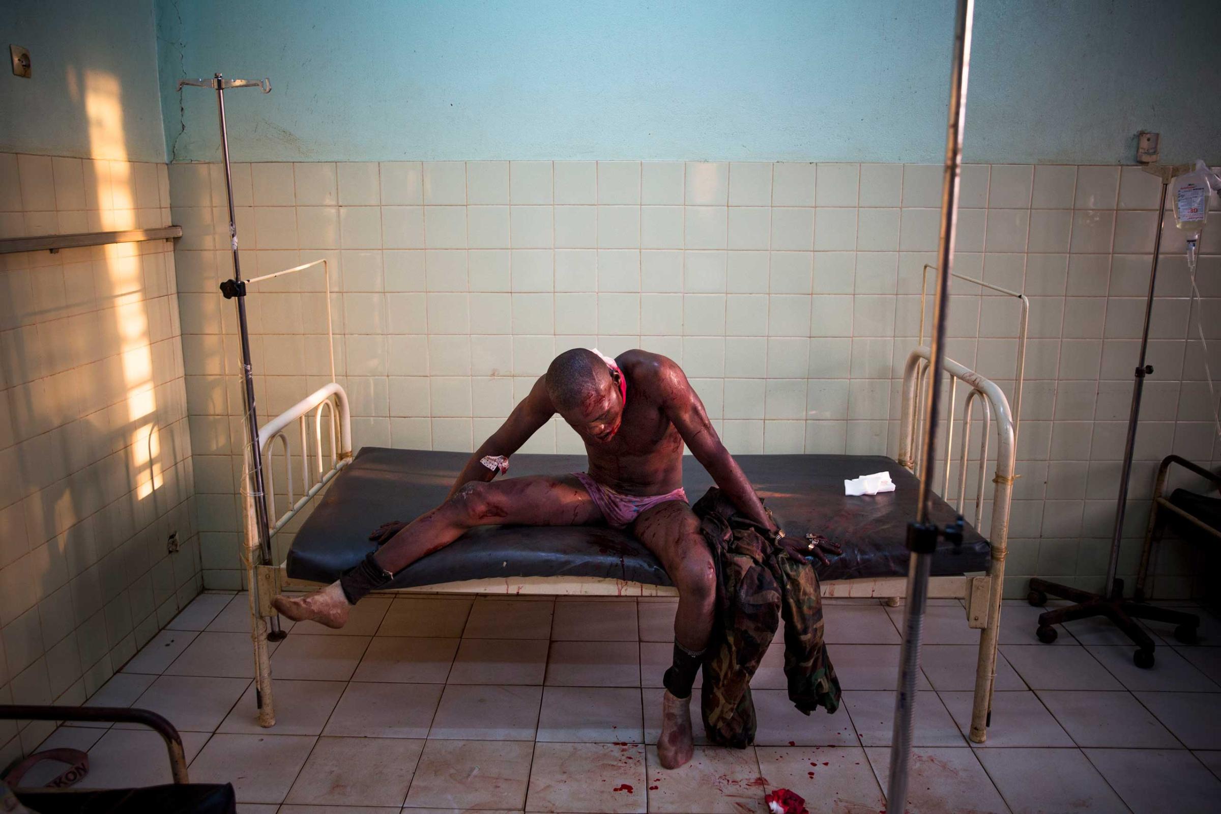 Jan. 31, 2014: A Central African soldier wounded during fighting with Muslims waits to be treated at the community hospital in Bangui.