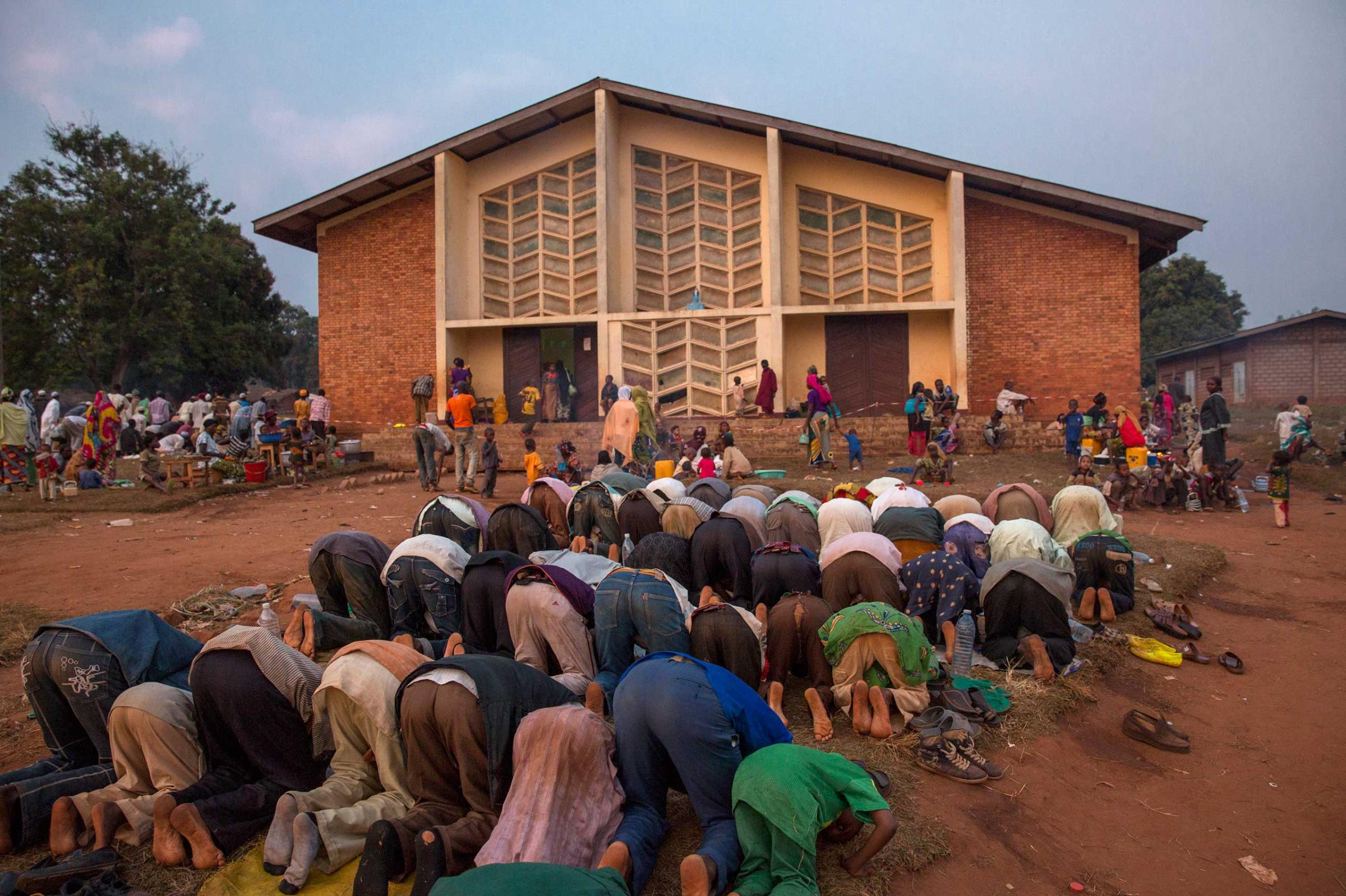 Jan. 25, 2014: Displaced Muslims pray in front of the church of Boali. Several hundred Muslims have taken refuge in this church, whose priest, Father Xavier-Arnaud Fagba, offered to shelter them from anti-balaka attacks. The compound is protected by MISCA forces.