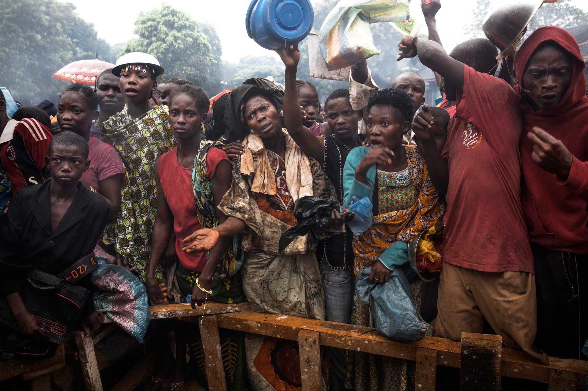 Dec. 9, 2013: Internally displaced people wait for food at the Don Bosco Center in Bangui. Some 18,000 Christians took refuge here.